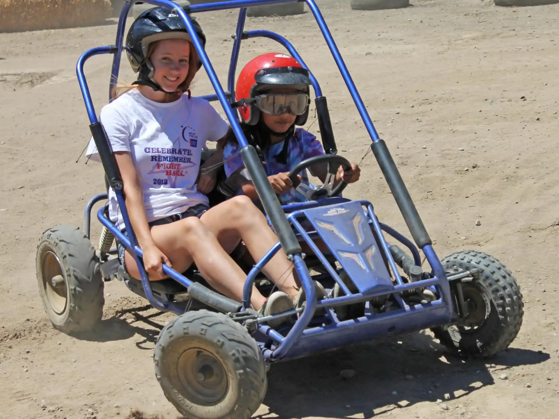 a couple of kids on a toy vehicle
