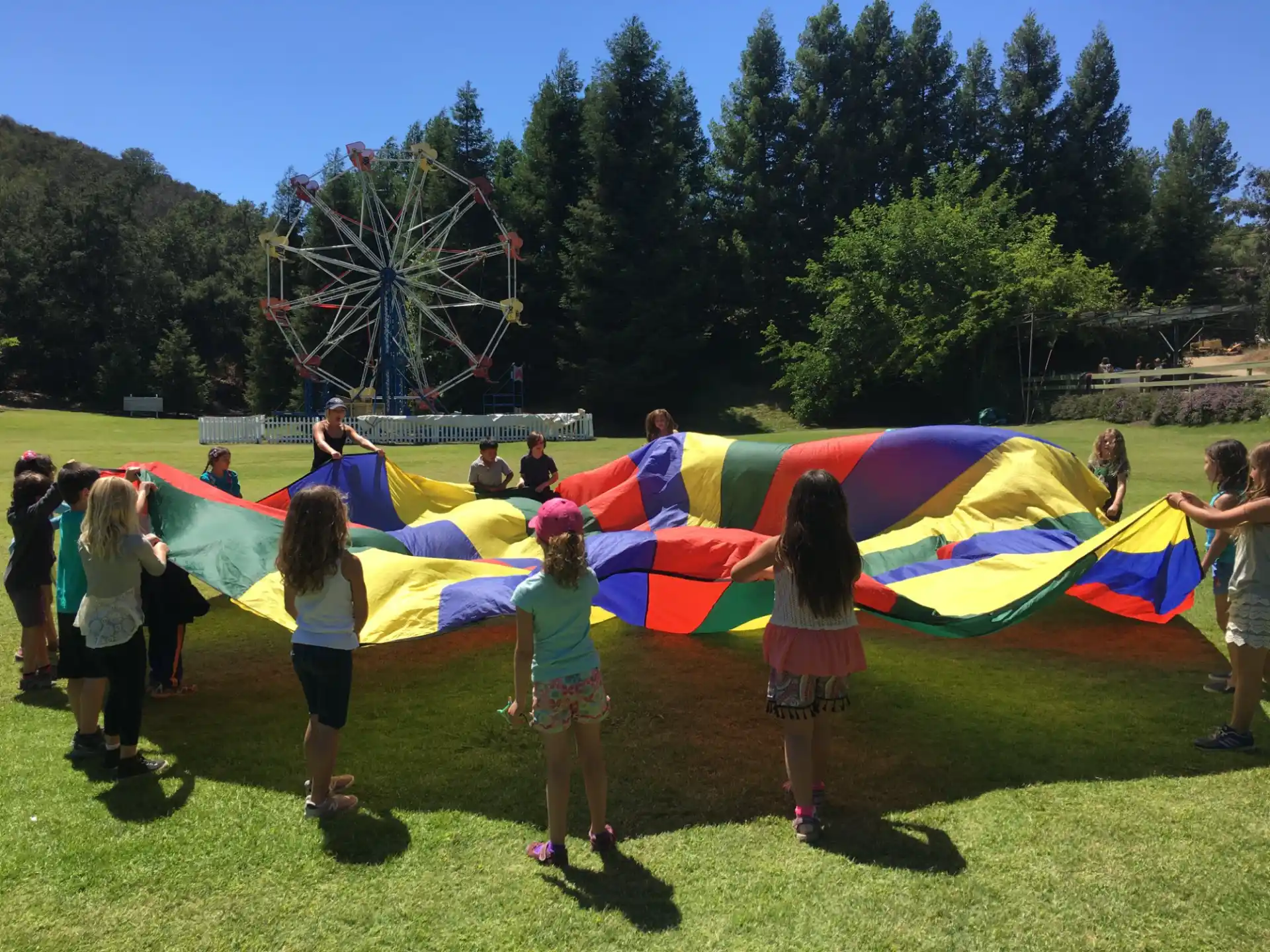a group of people holding a colorful kite