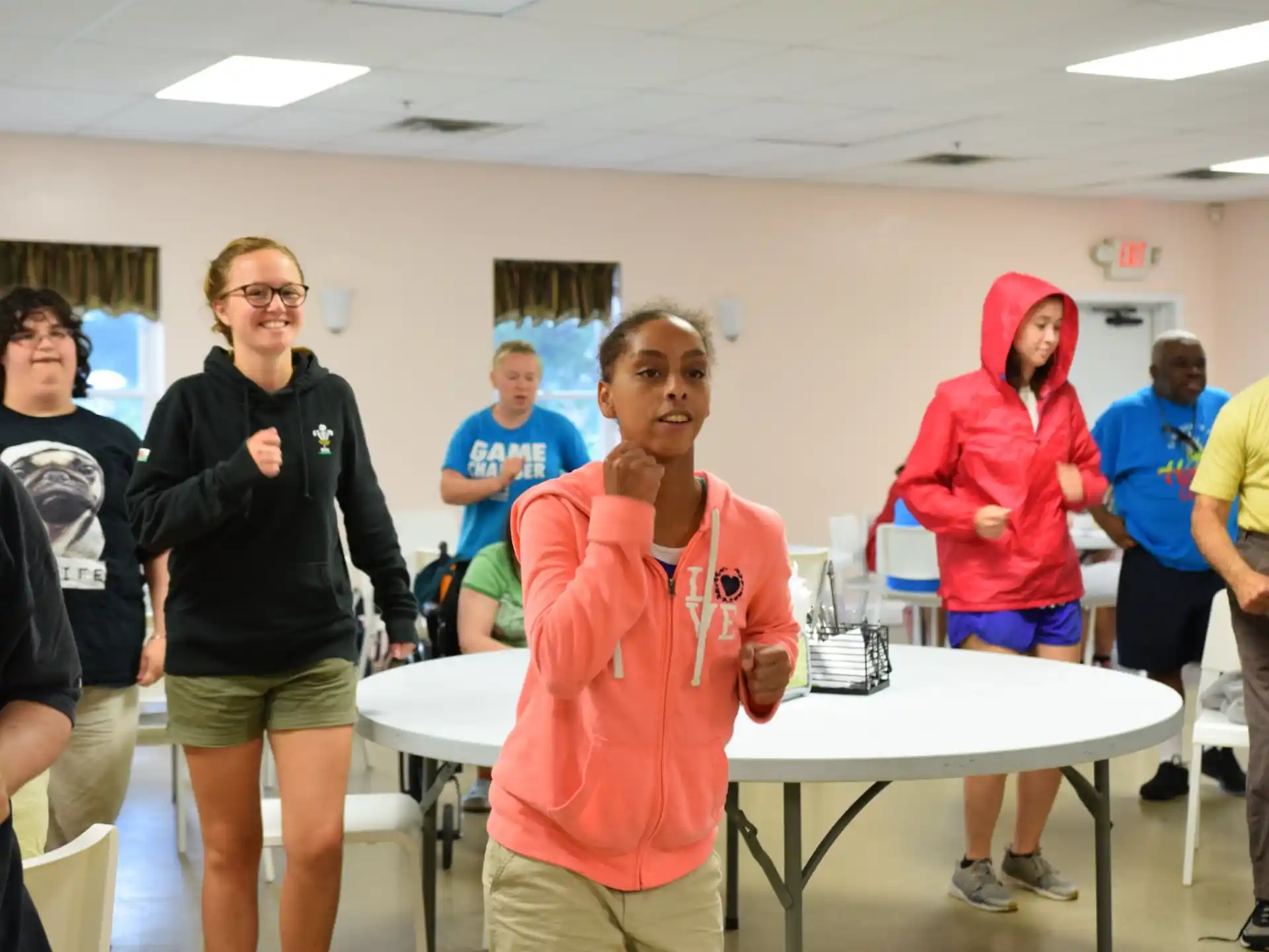 a group of people standing around a table