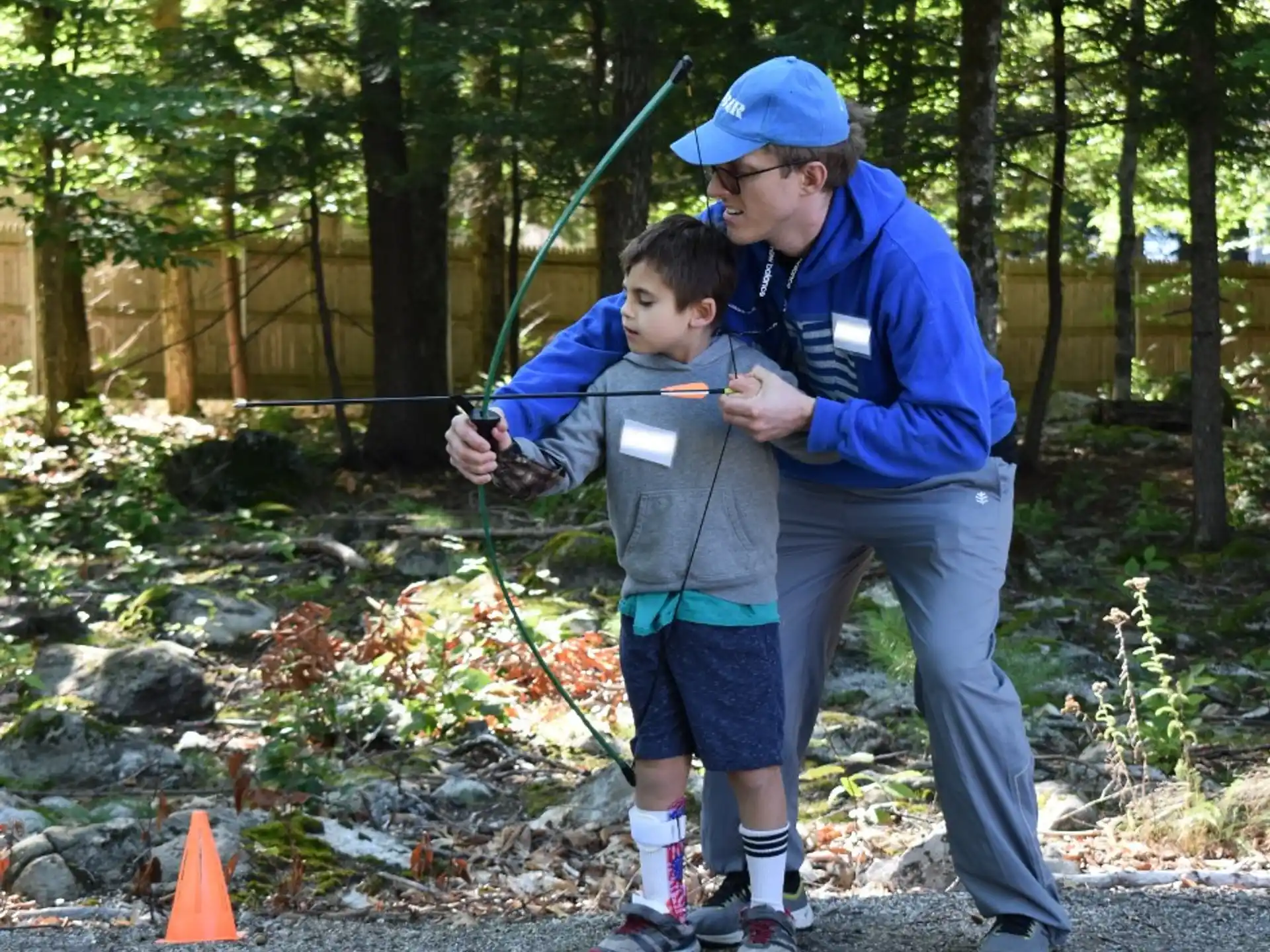 a man and a boy holding a fishing pole