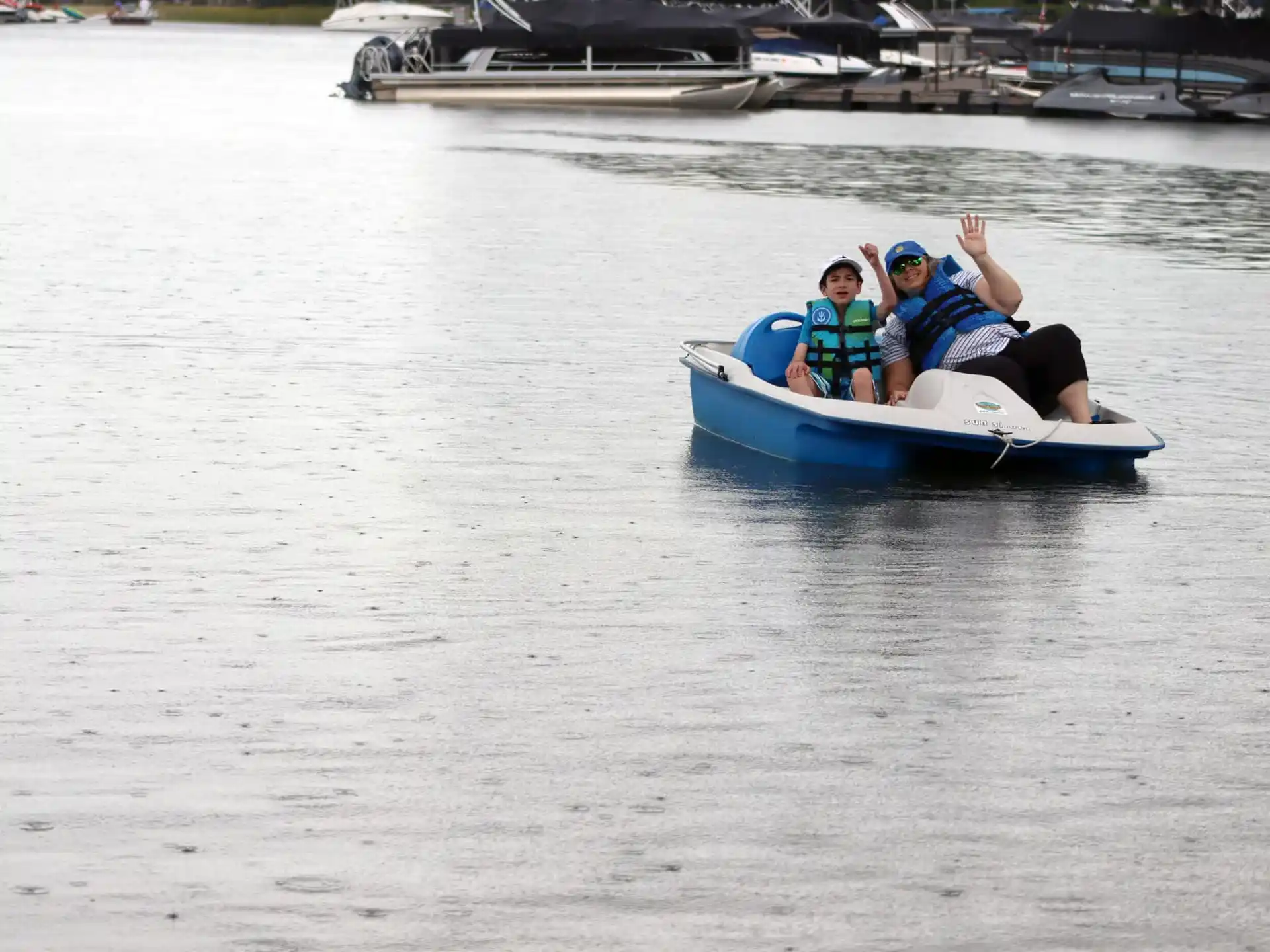 a man and a woman on a small boat in the water
