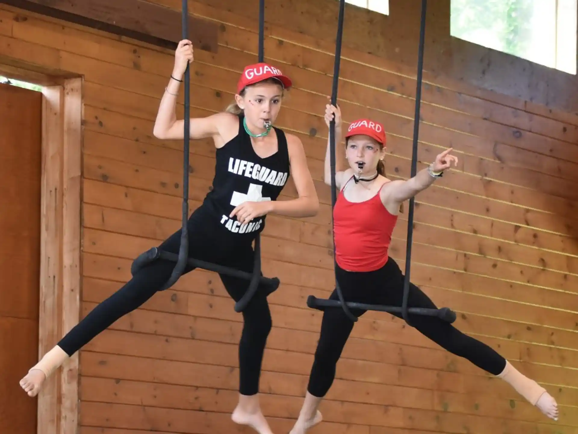 two women wearing helmets and dancing