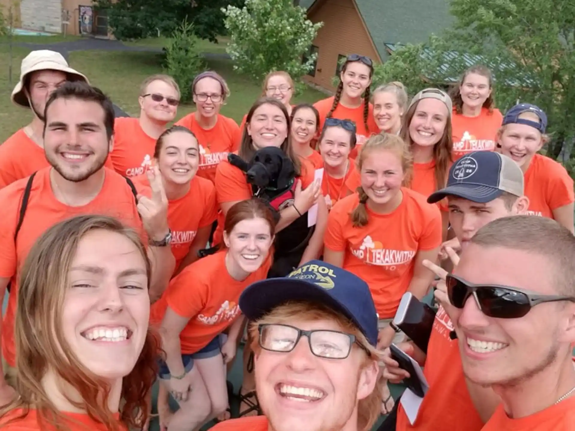 a group of people wearing orange shirts
