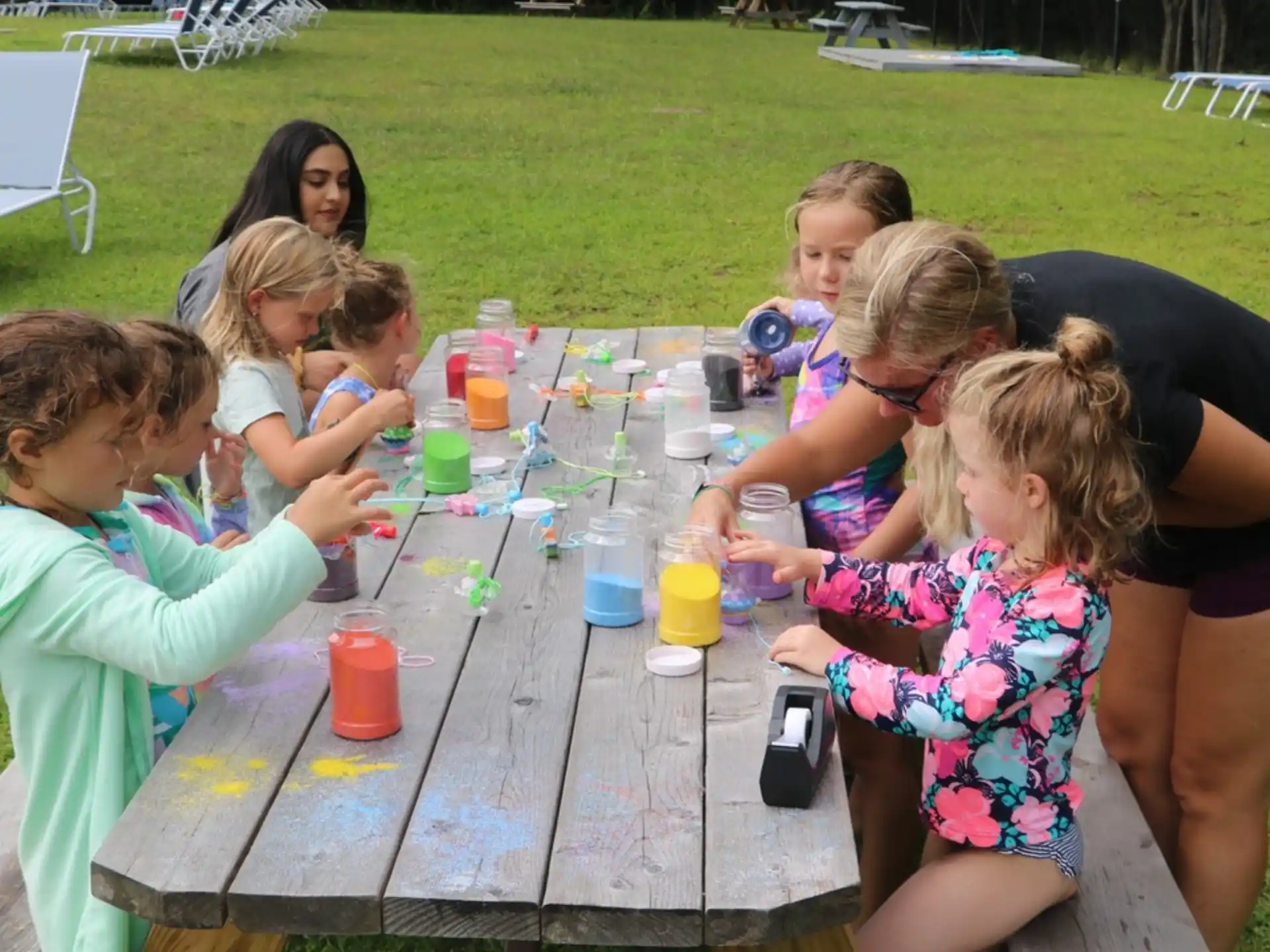 a group of children playing with water bottles on a table