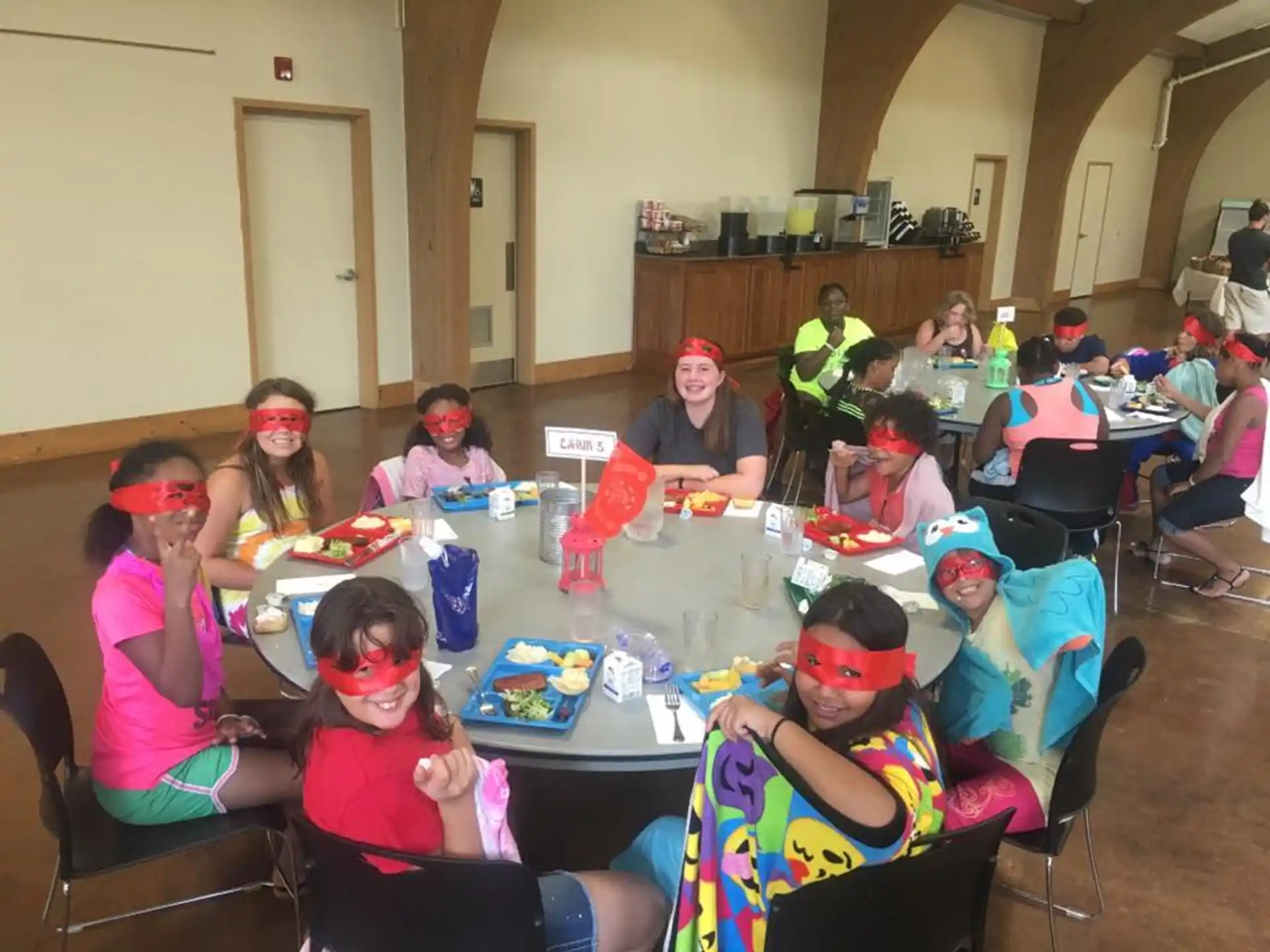 a group of children sitting around a table