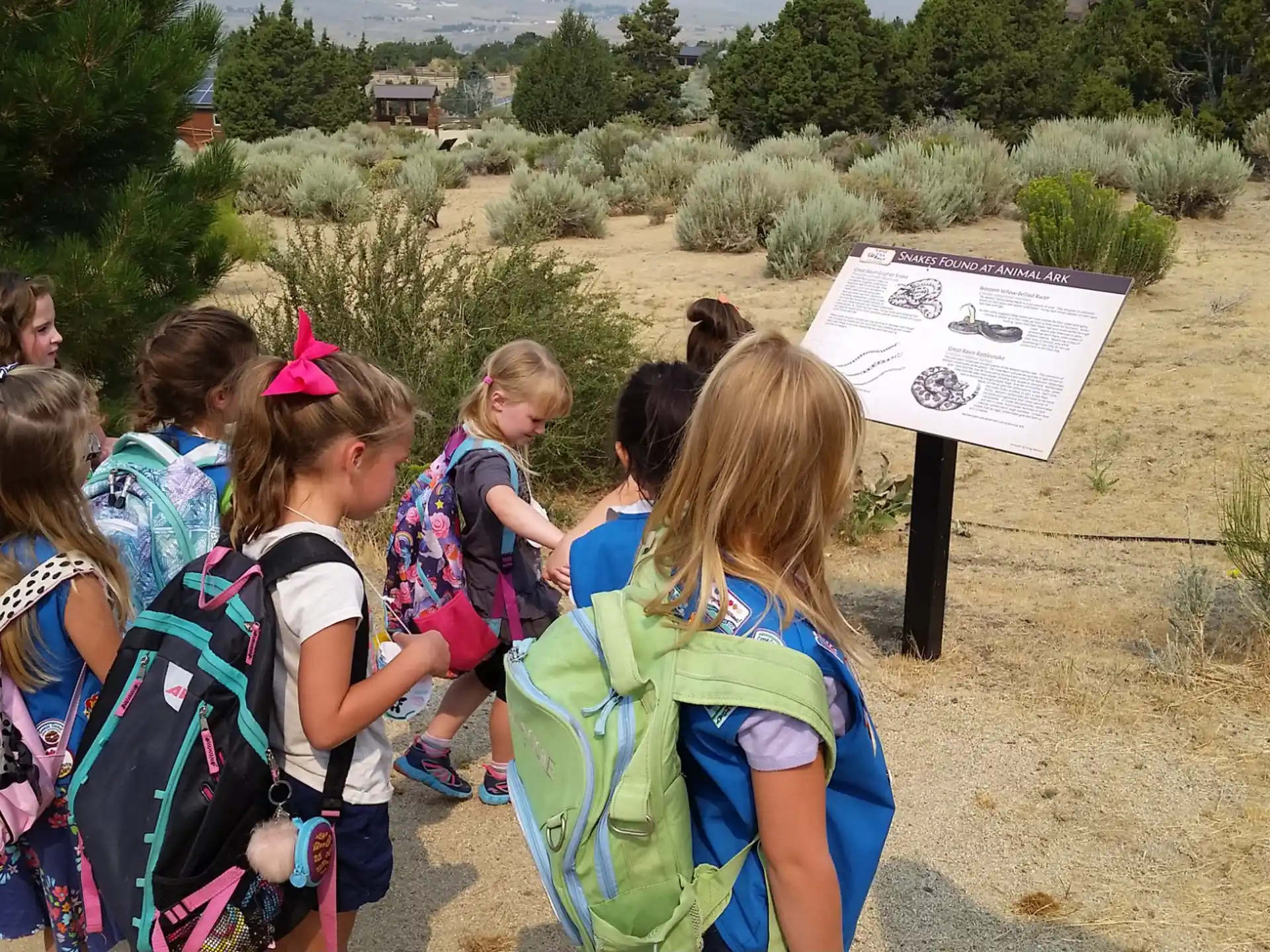 a group of children standing next to a sign