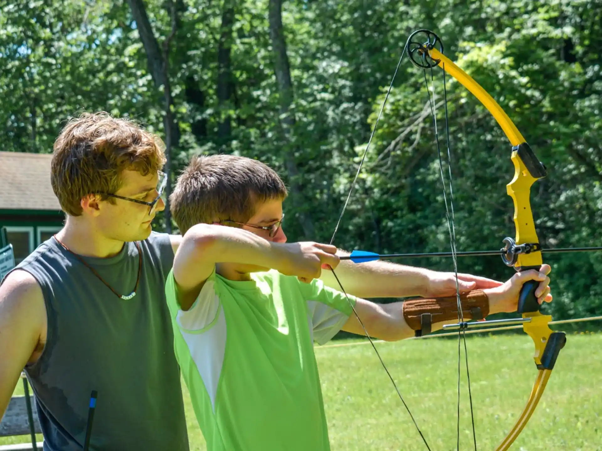 a couple of men shooting a bow and arrow