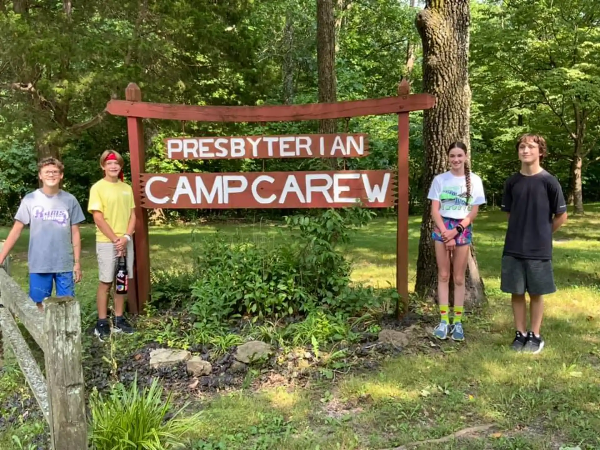 a group of people standing next to a sign