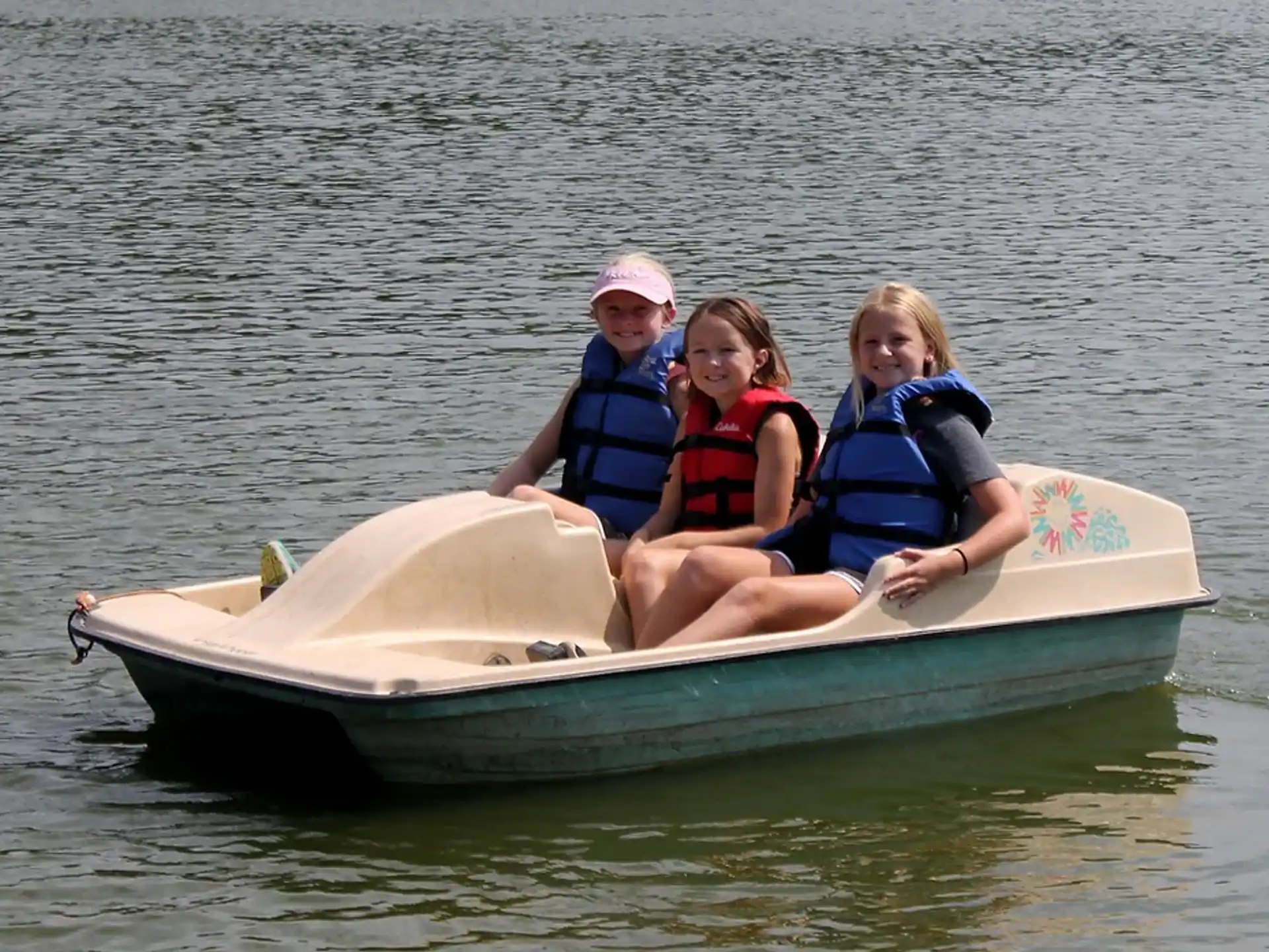 a group of people on a small boat in the water