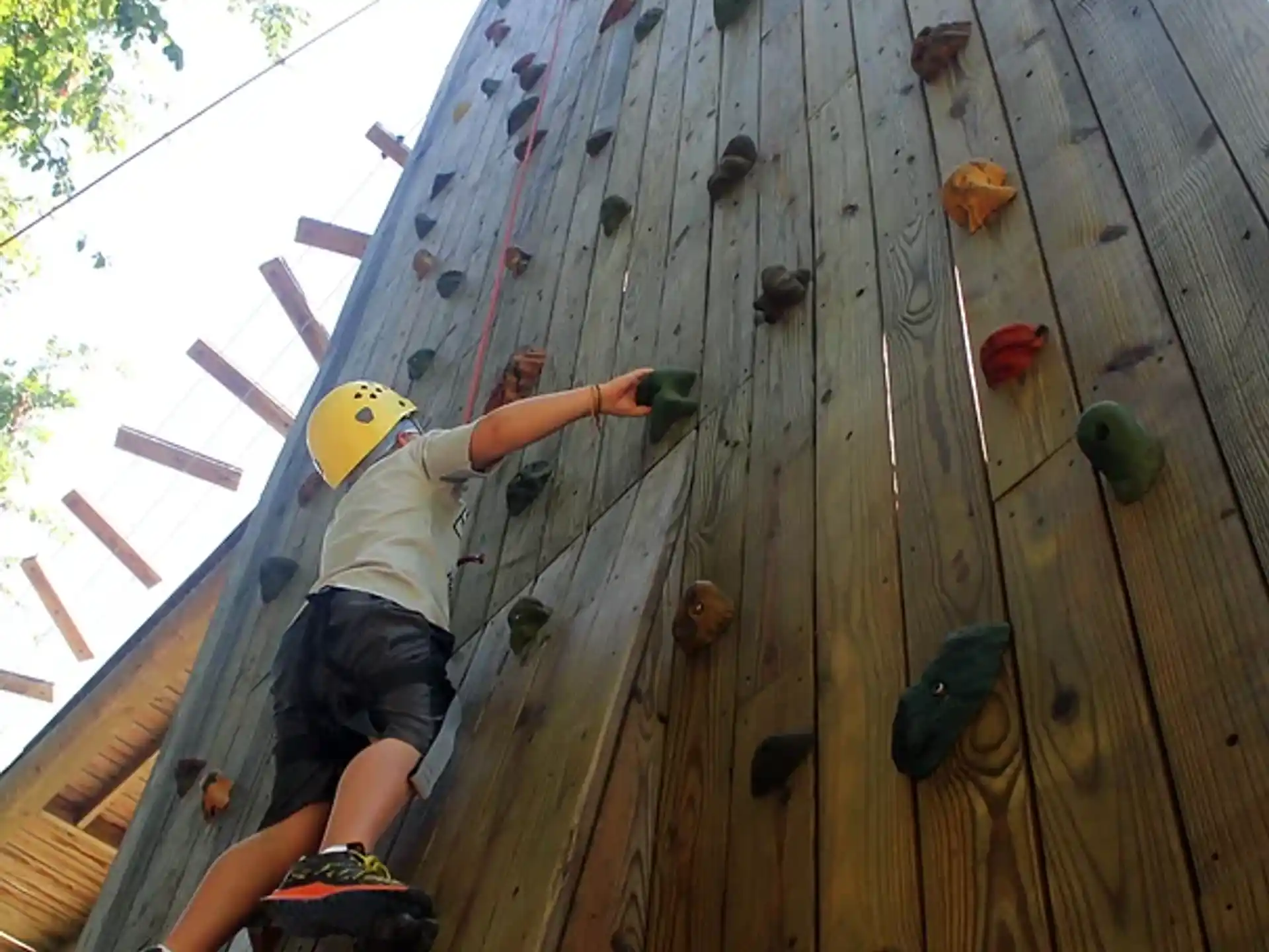 a man climbing a wooden wall