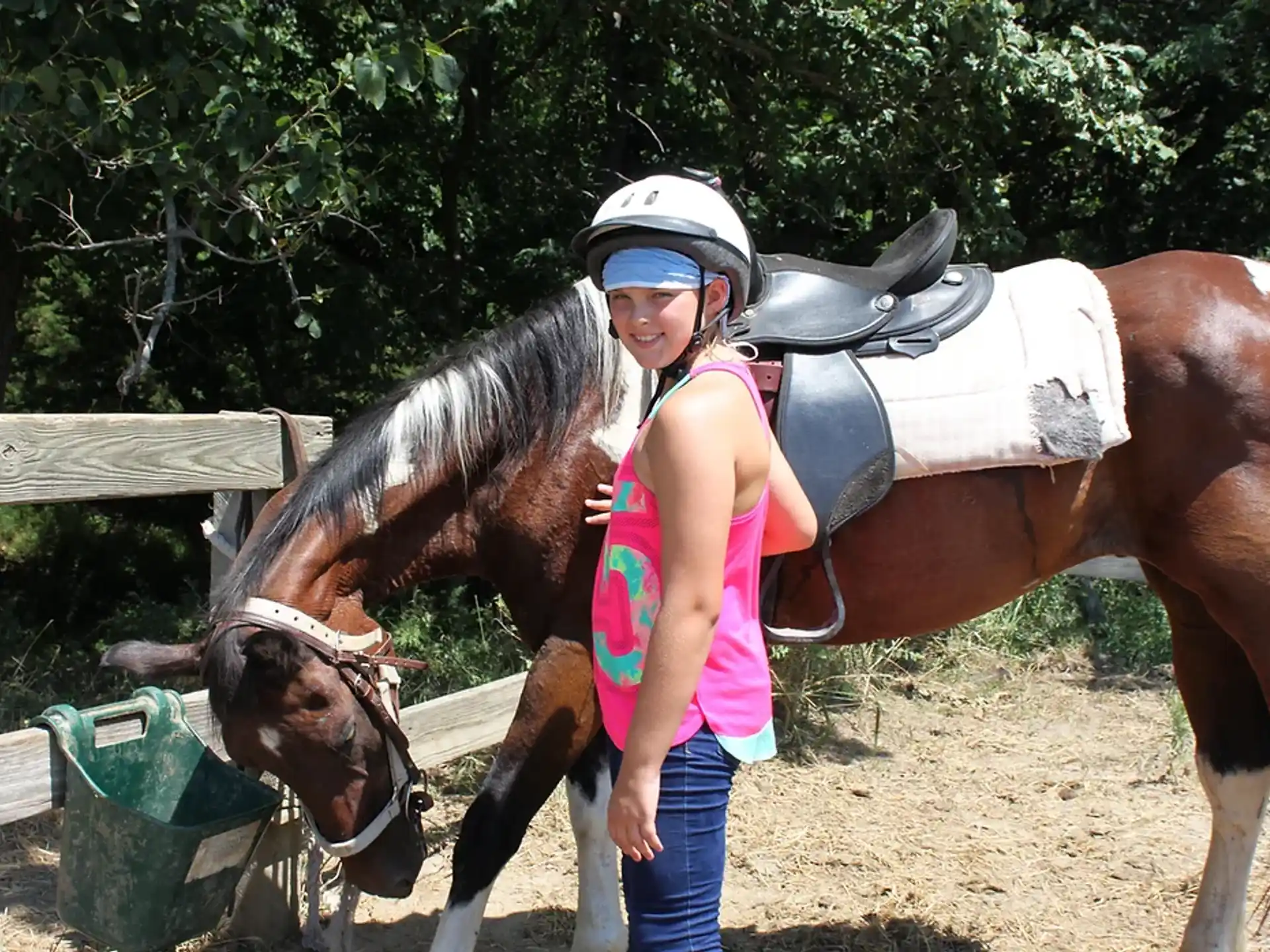 a person standing next to a horse