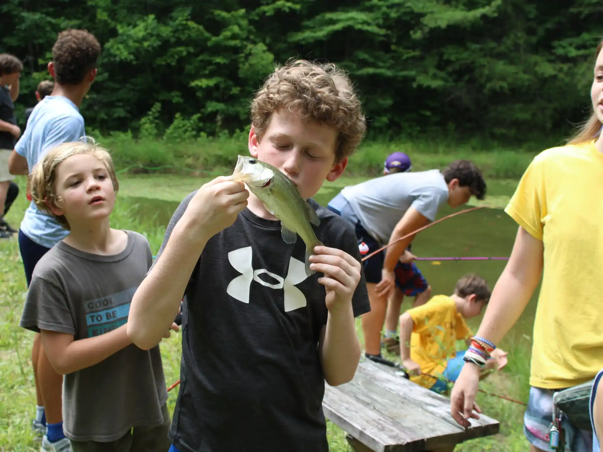 a group of people holding a green snake