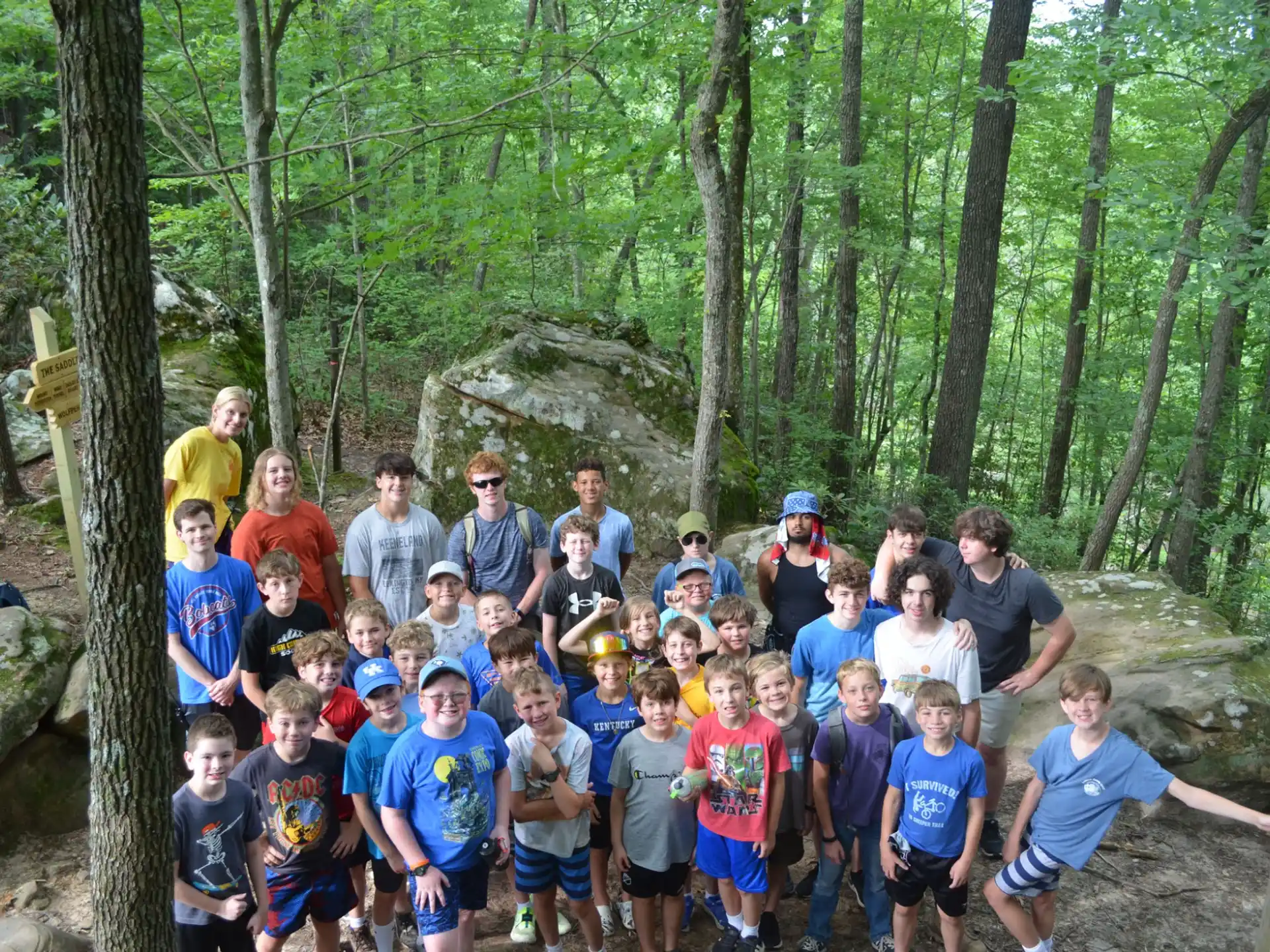 a group of people posing for a photo in the woods