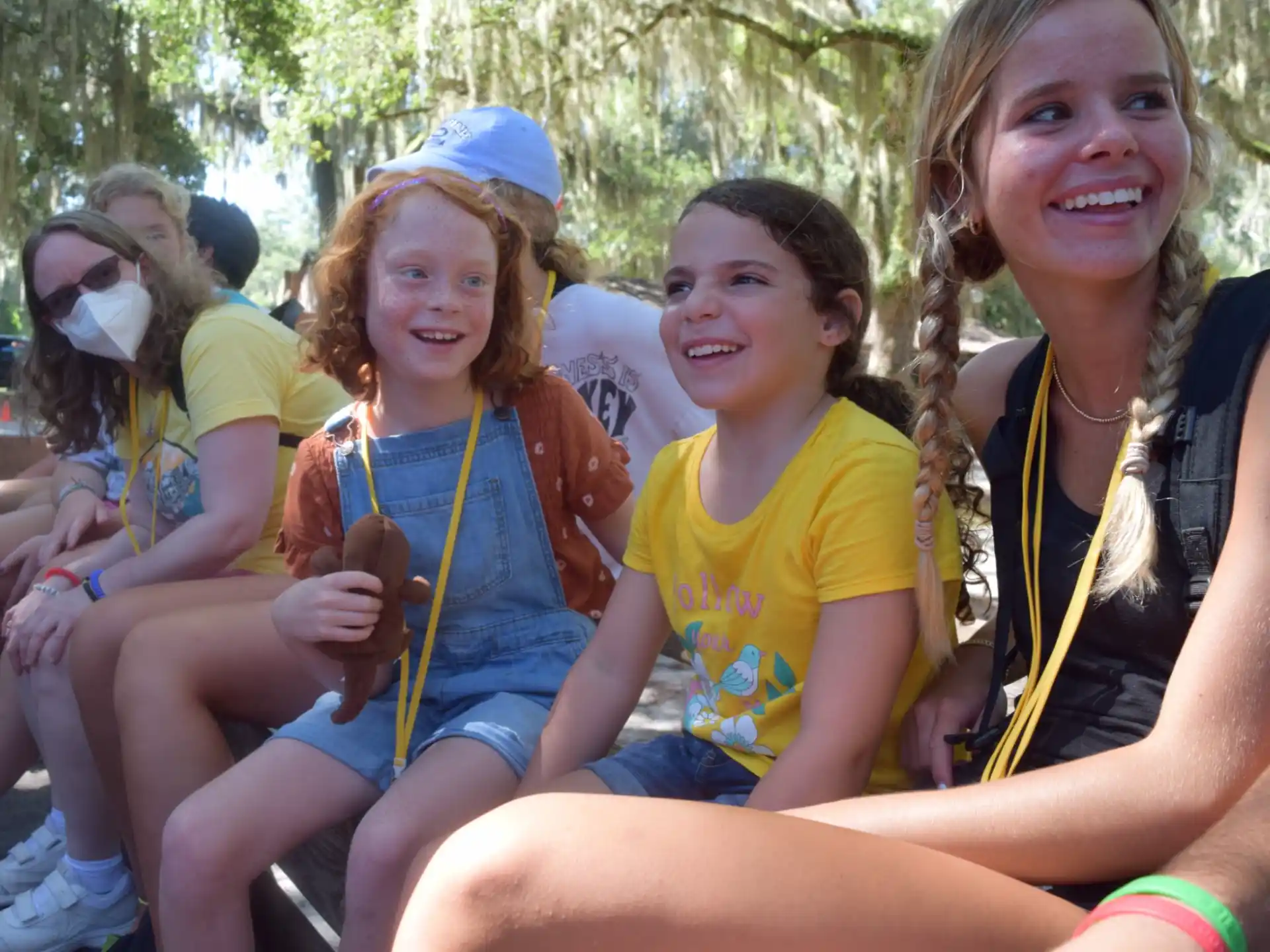 a group of girls sitting on a bench