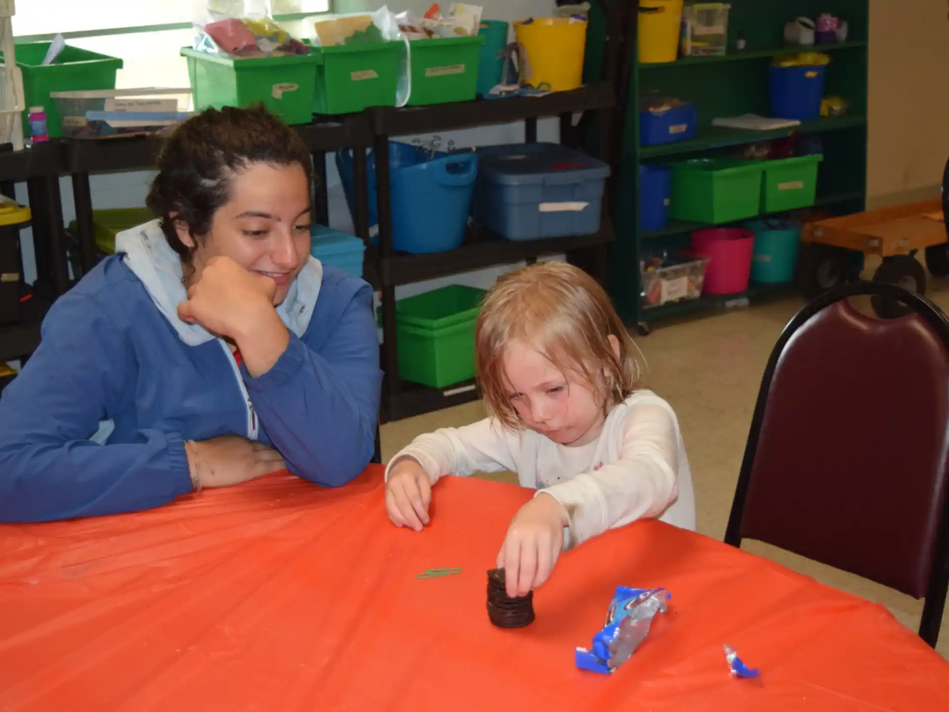 a person and a child playing with a toy