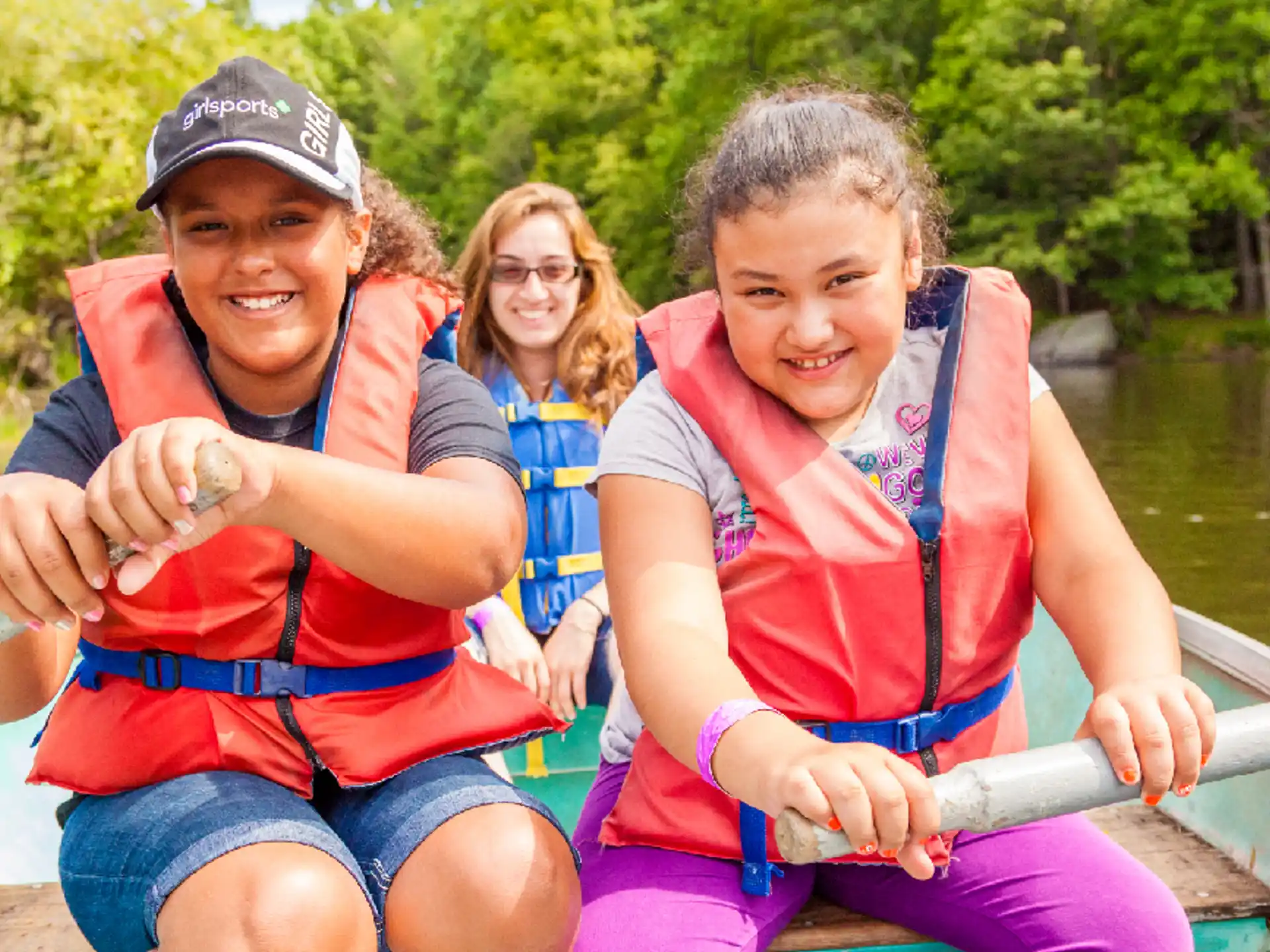 a group of kids in a boat