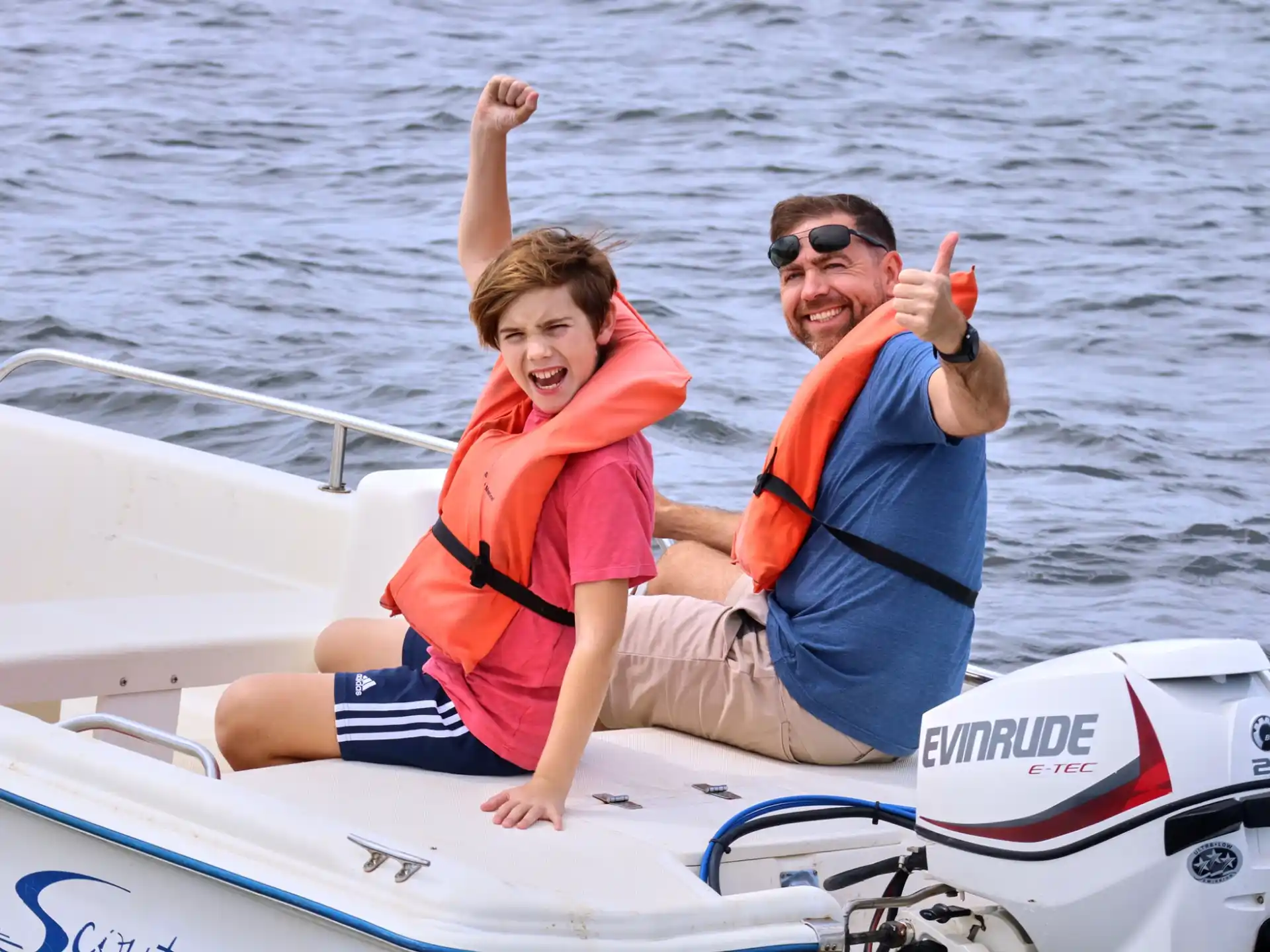a person and a boy on a boat
