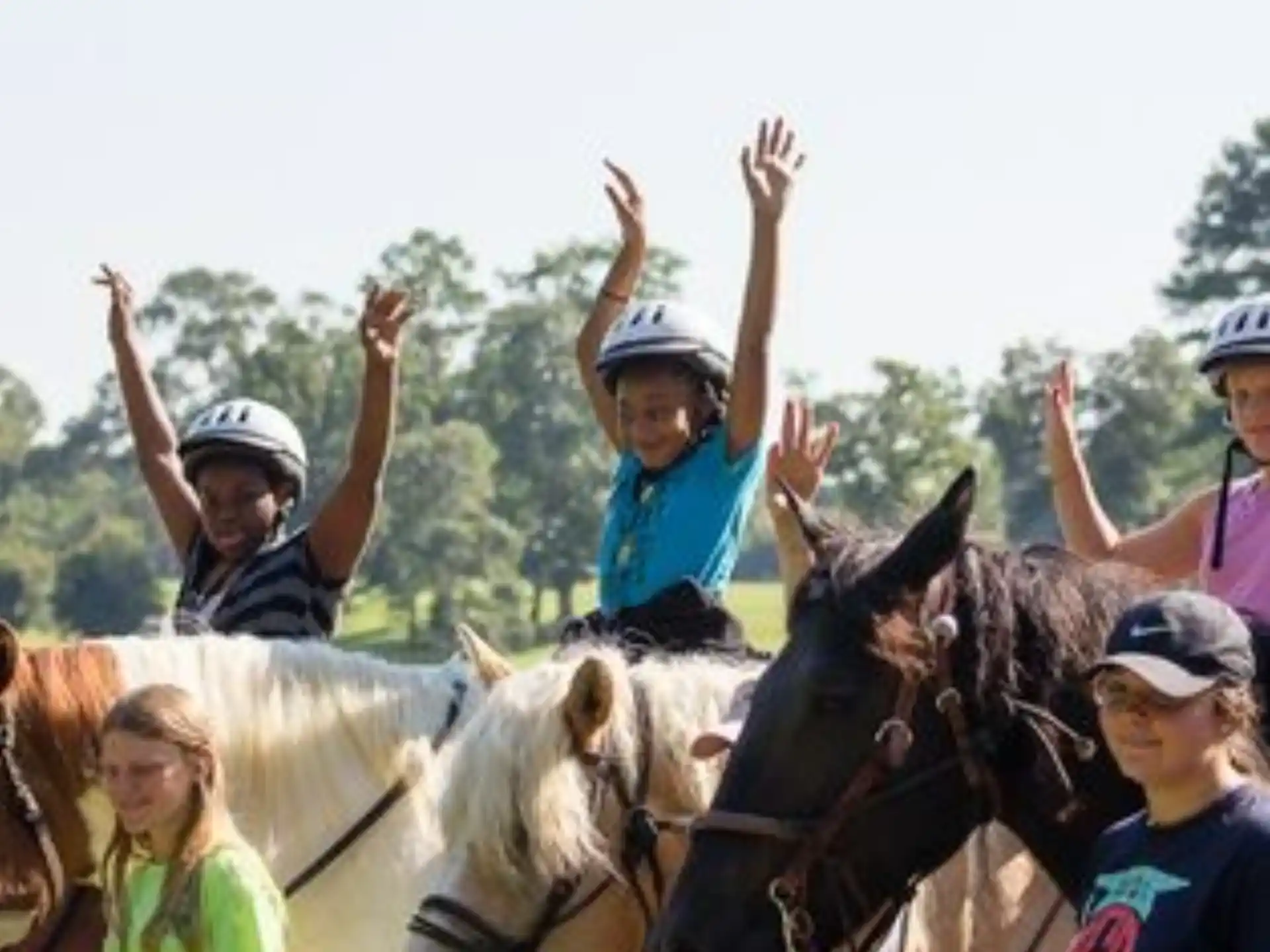 a group of people riding horses