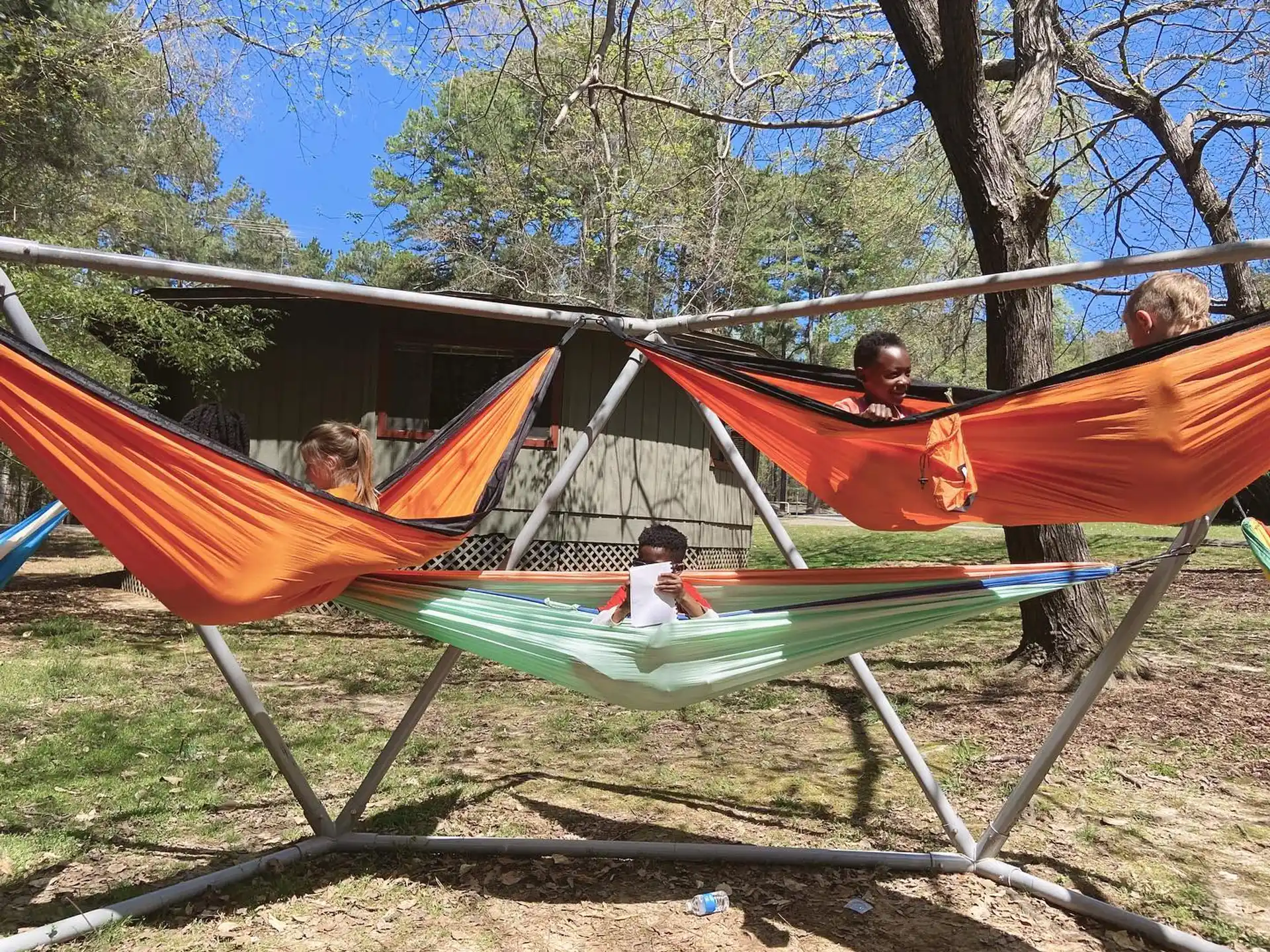 a group of kids playing in a hammock
