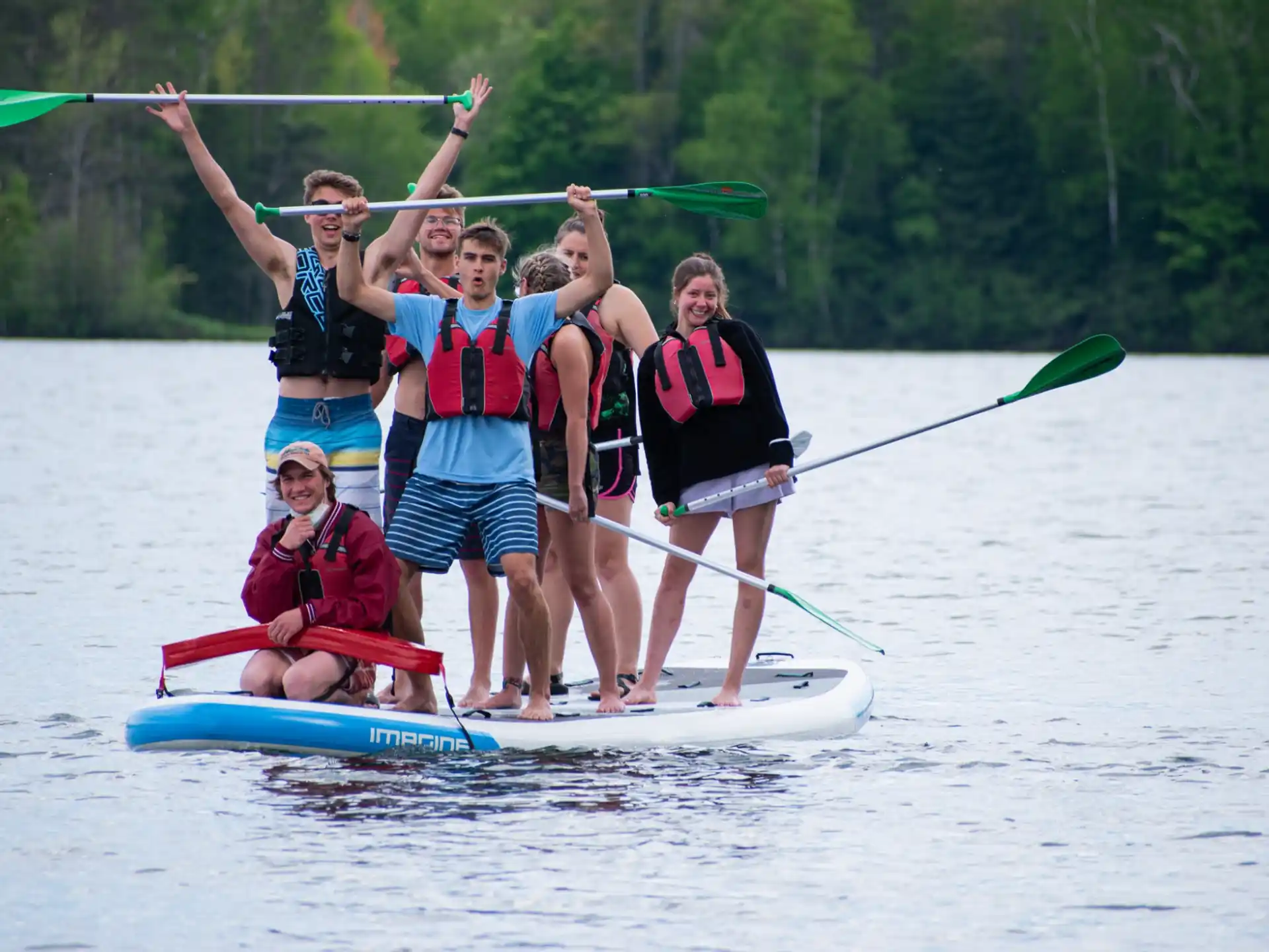 a group of people on a paddle board