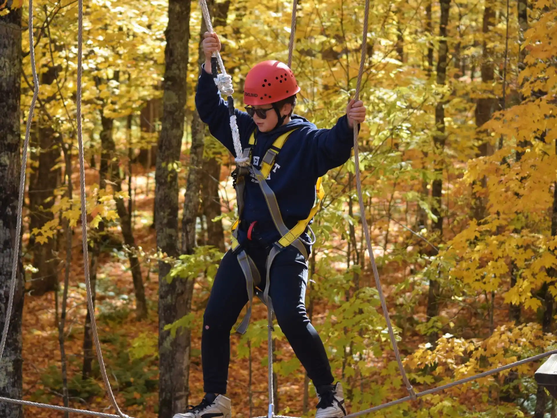 a person wearing a helmet and climbing a rope