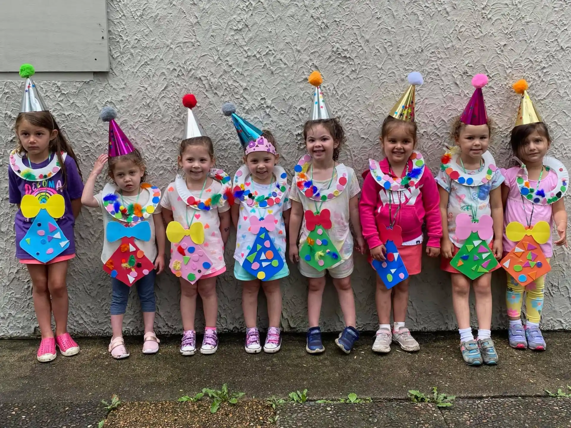 a group of girls wearing party hats