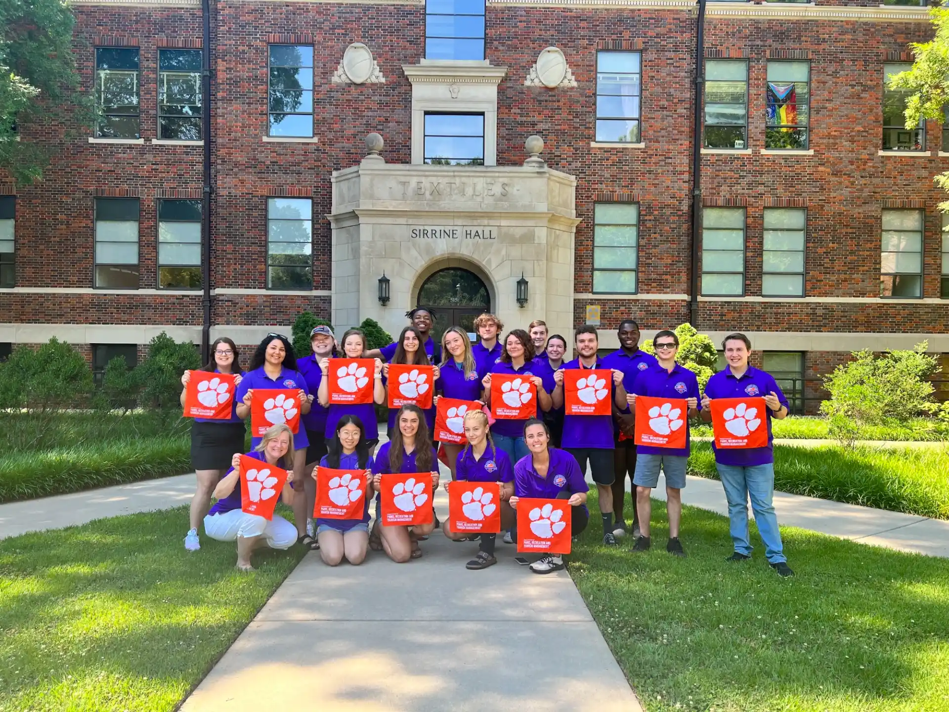 a group of people posing for a photo in front of a building