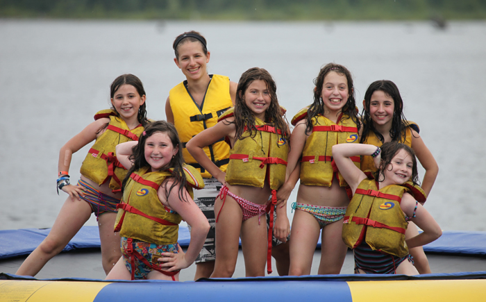 a group of women in swimsuits posing for a photo