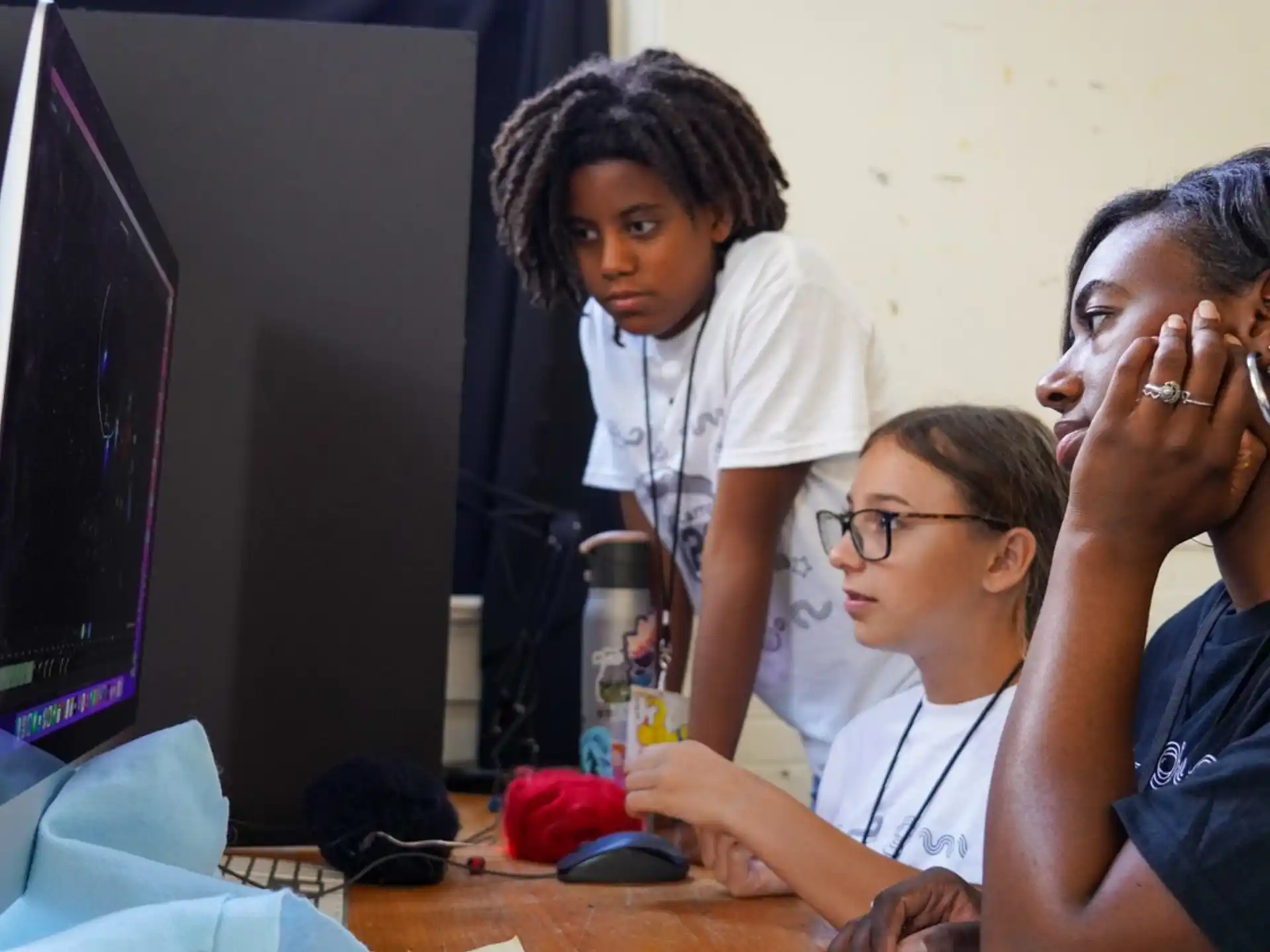 a group of people sitting at a computer