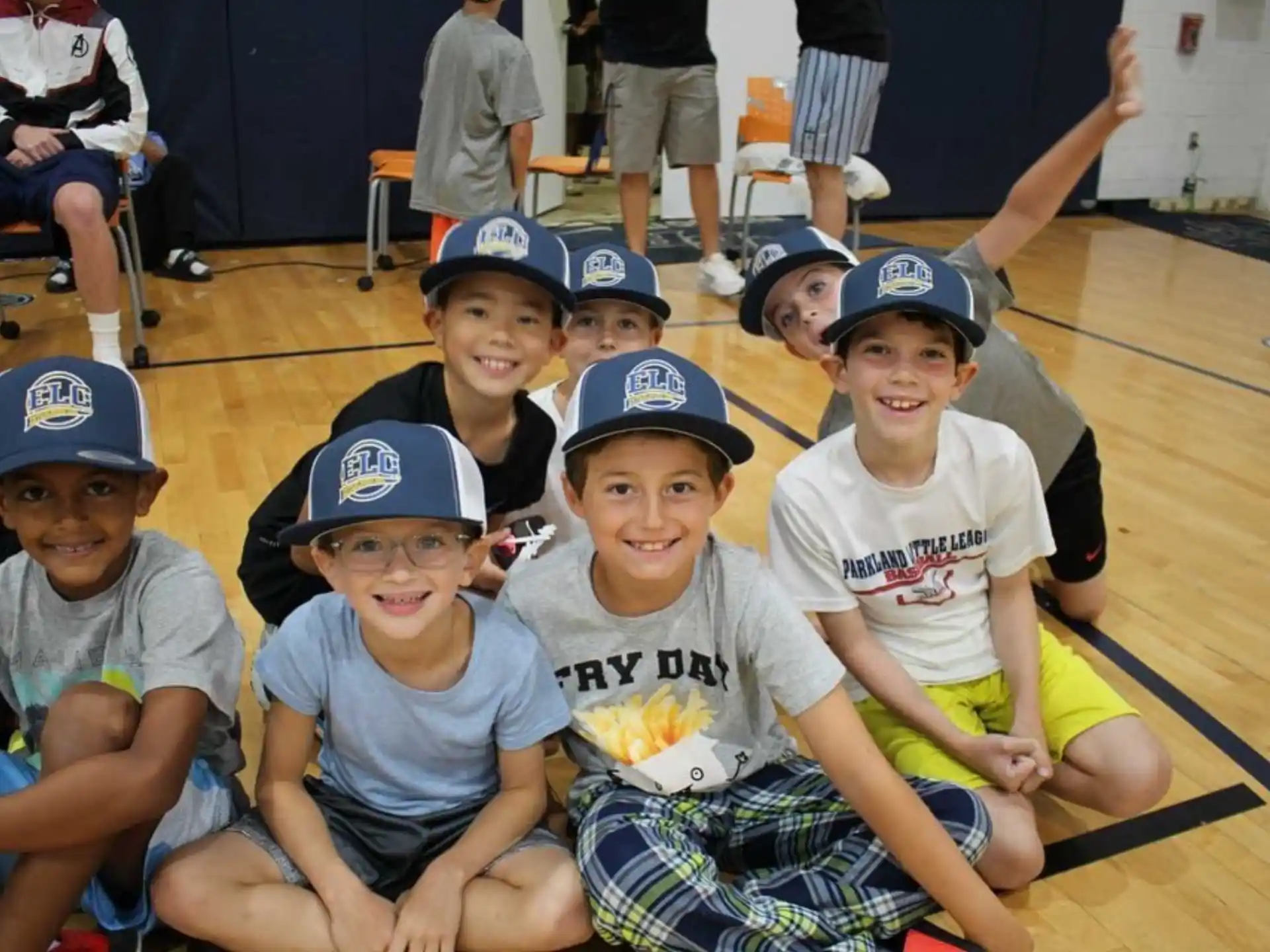 a group of kids wearing baseball hats