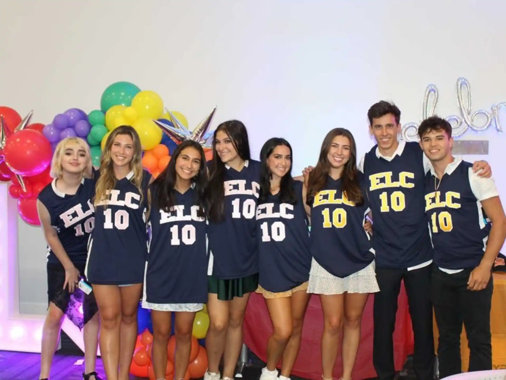 a group of people posing for a photo with balloons