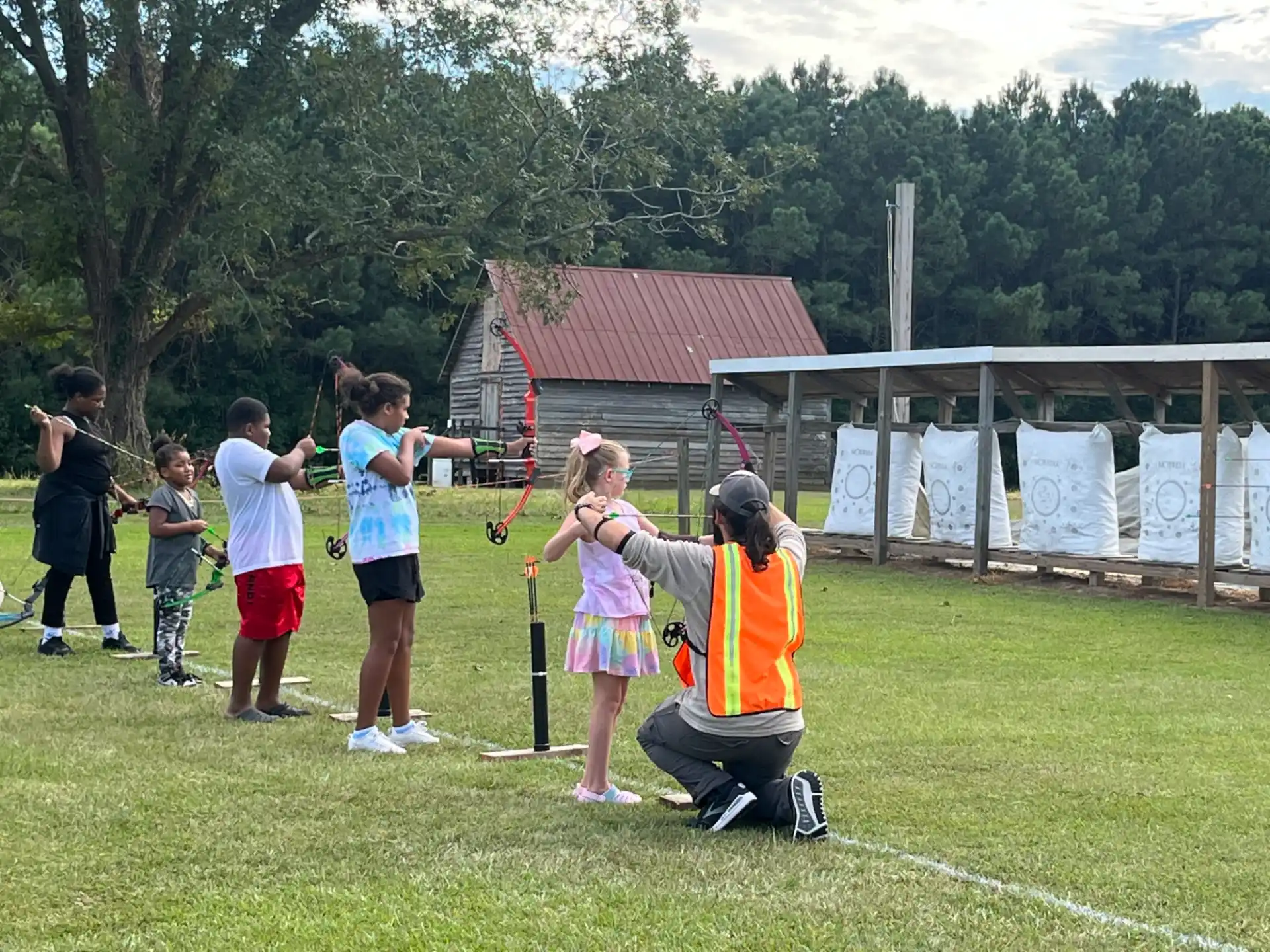 a group of people playing with bows and arrows