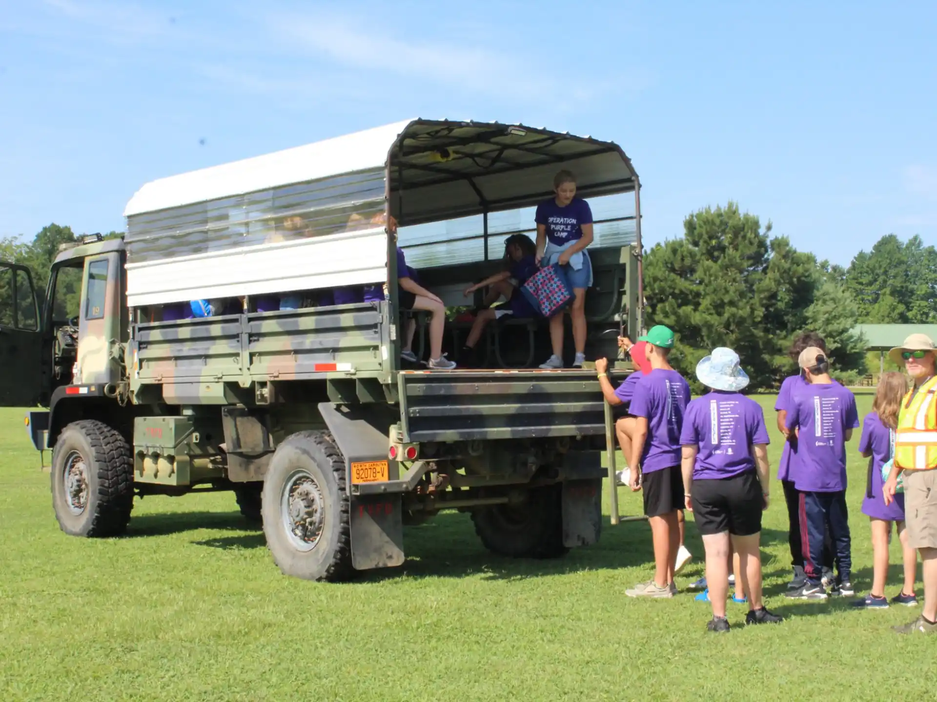 a group of people standing next to a truck