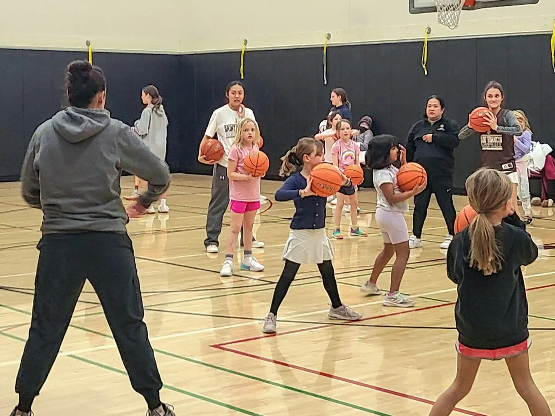 a group of people playing basketball