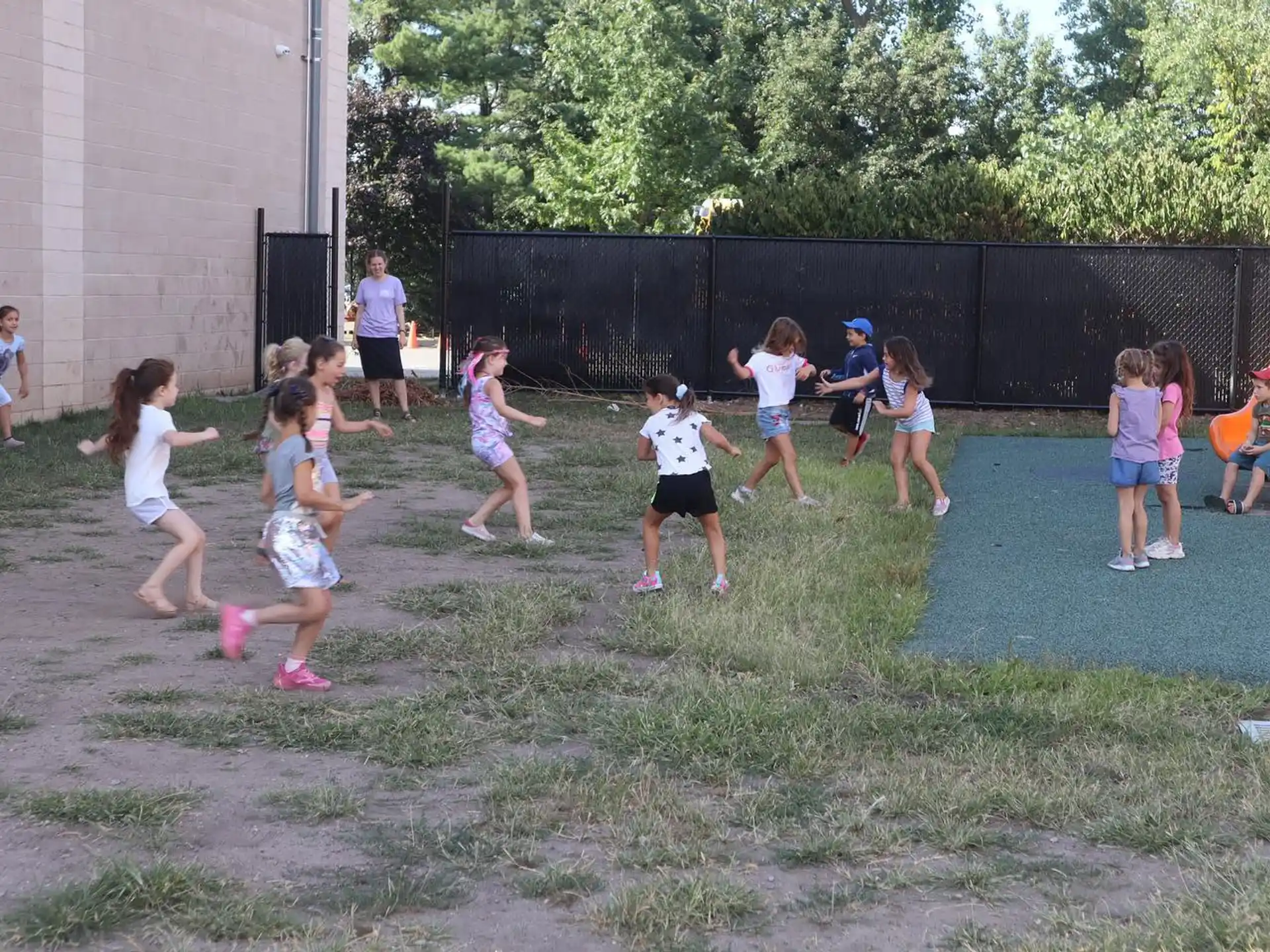 a group of children playing in a yard