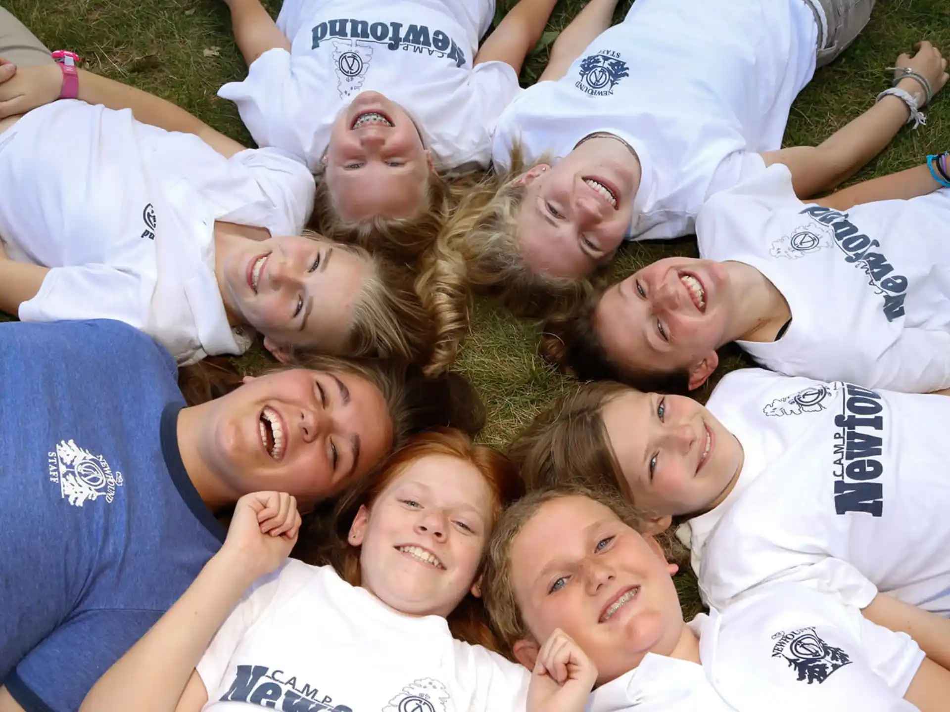 a group of children lying on the ground smiling