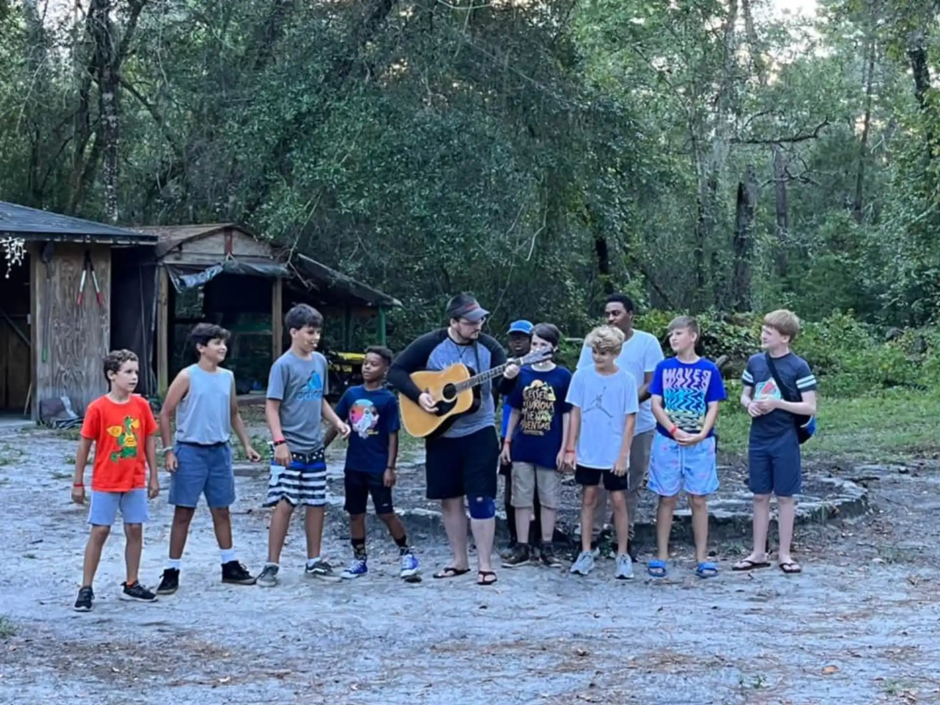 a group of people standing in a line holding a guitar