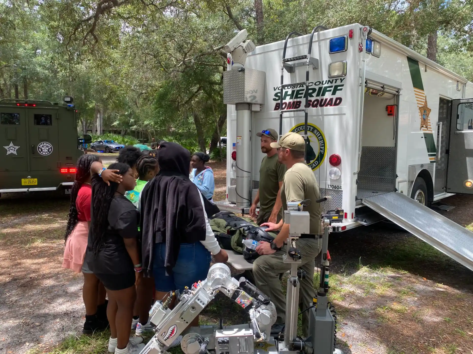 a group of people standing around a truck