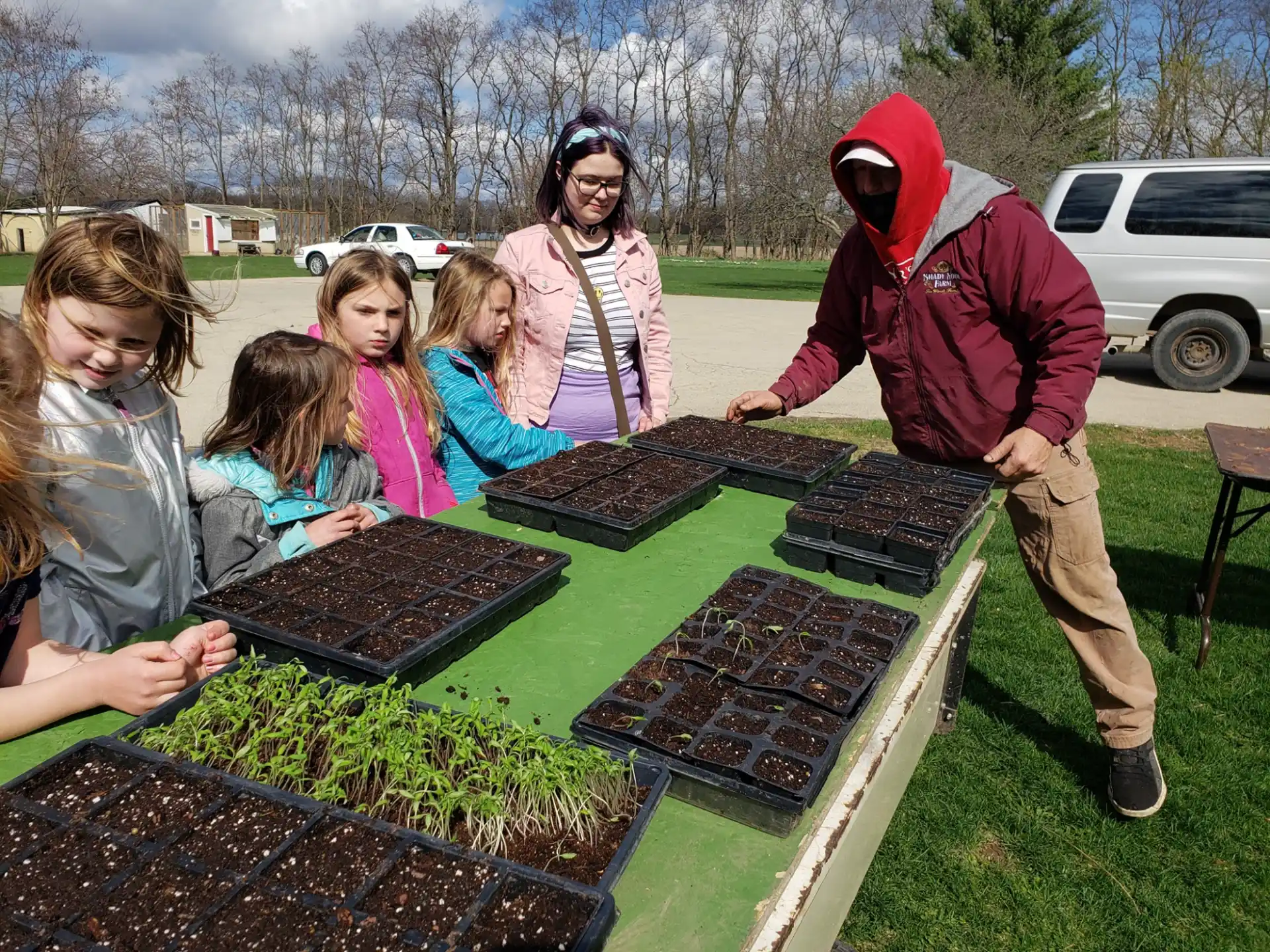 a group of people looking at plants