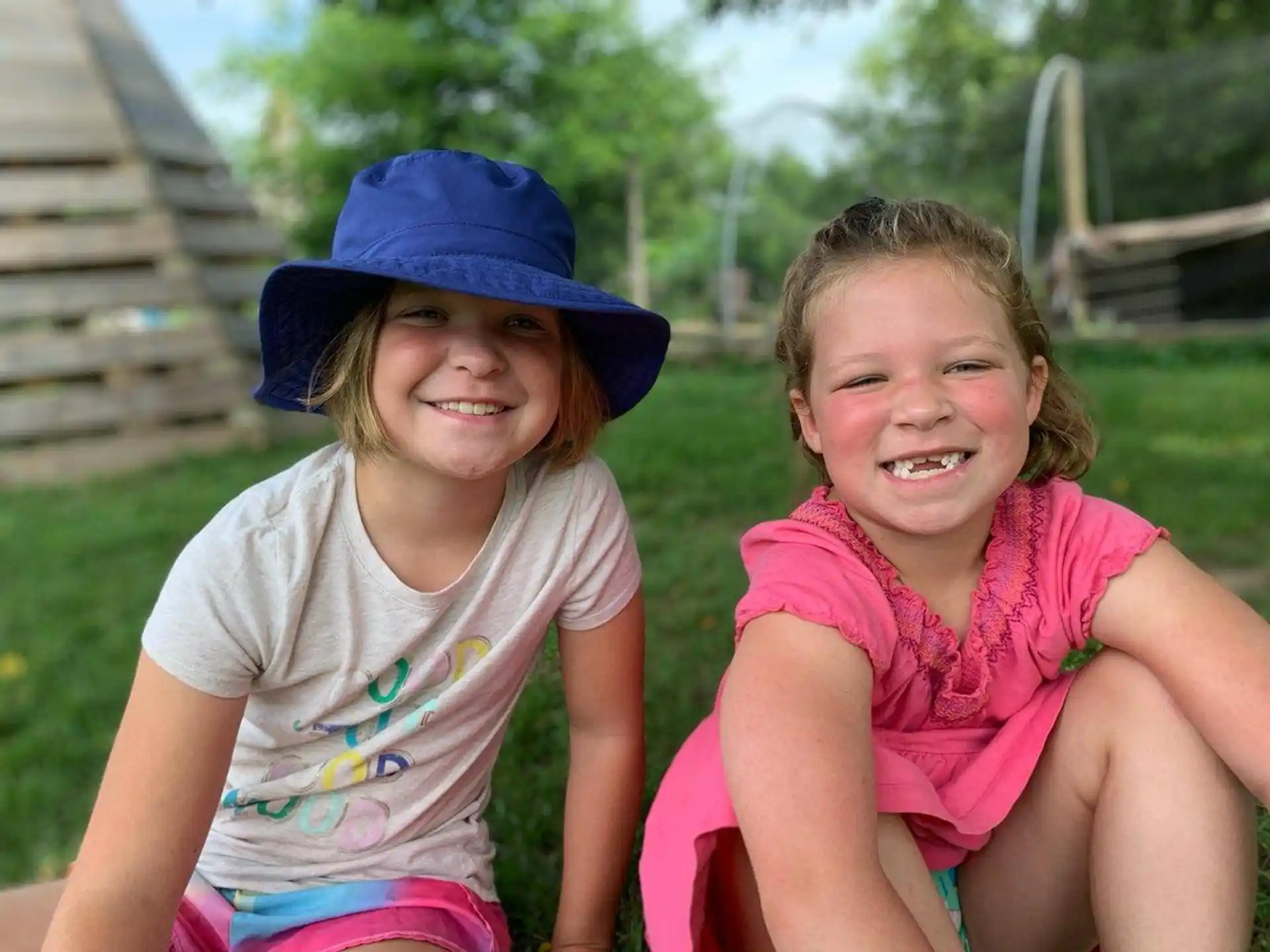 two girls sitting on a bench