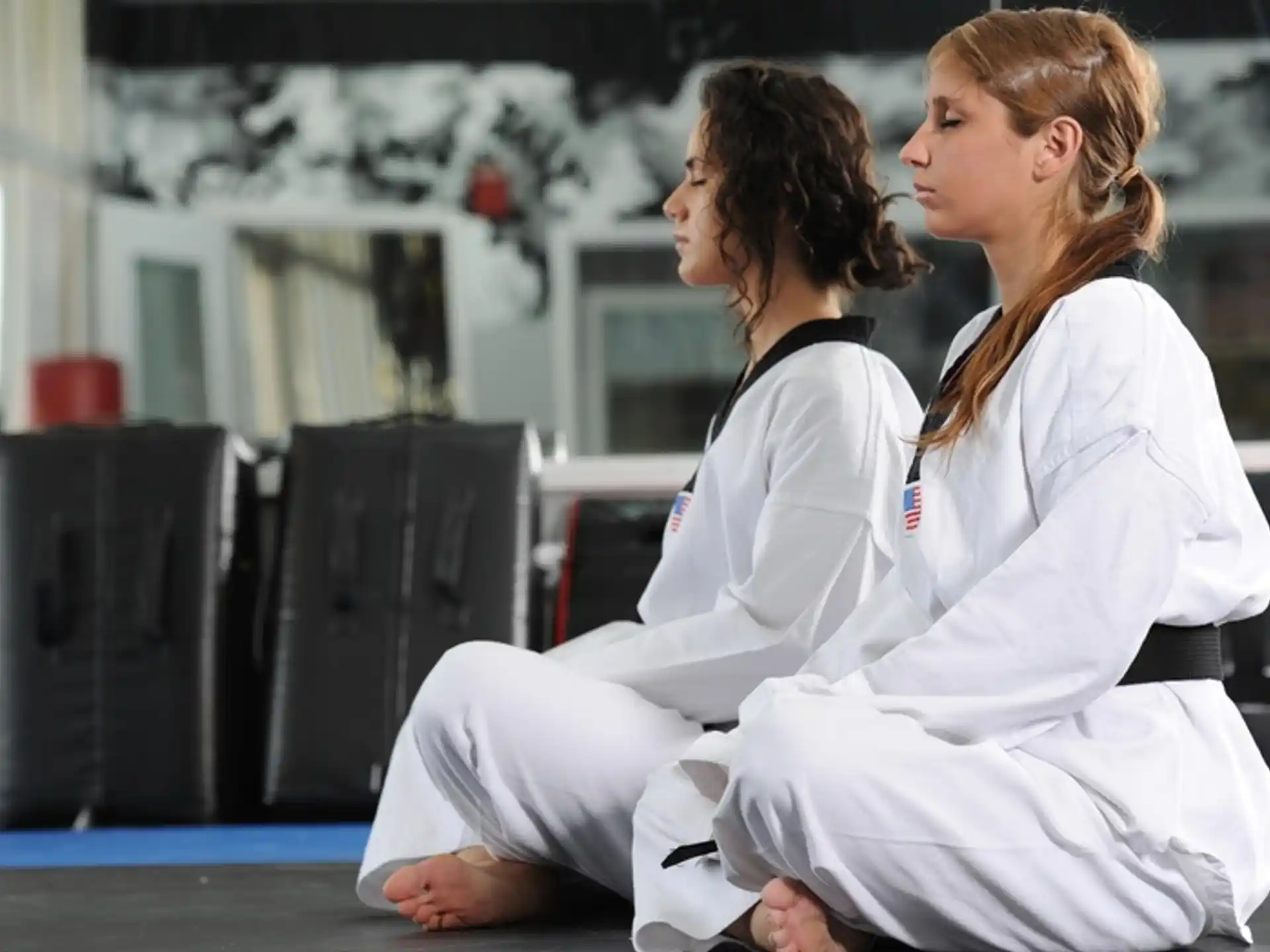a couple of women in karate uniforms