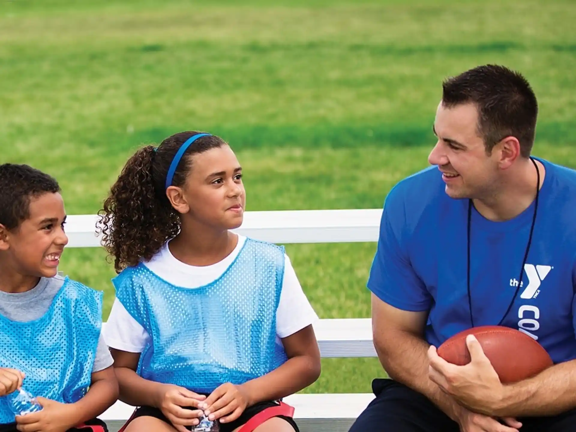 a man and a couple of children sitting on a bench