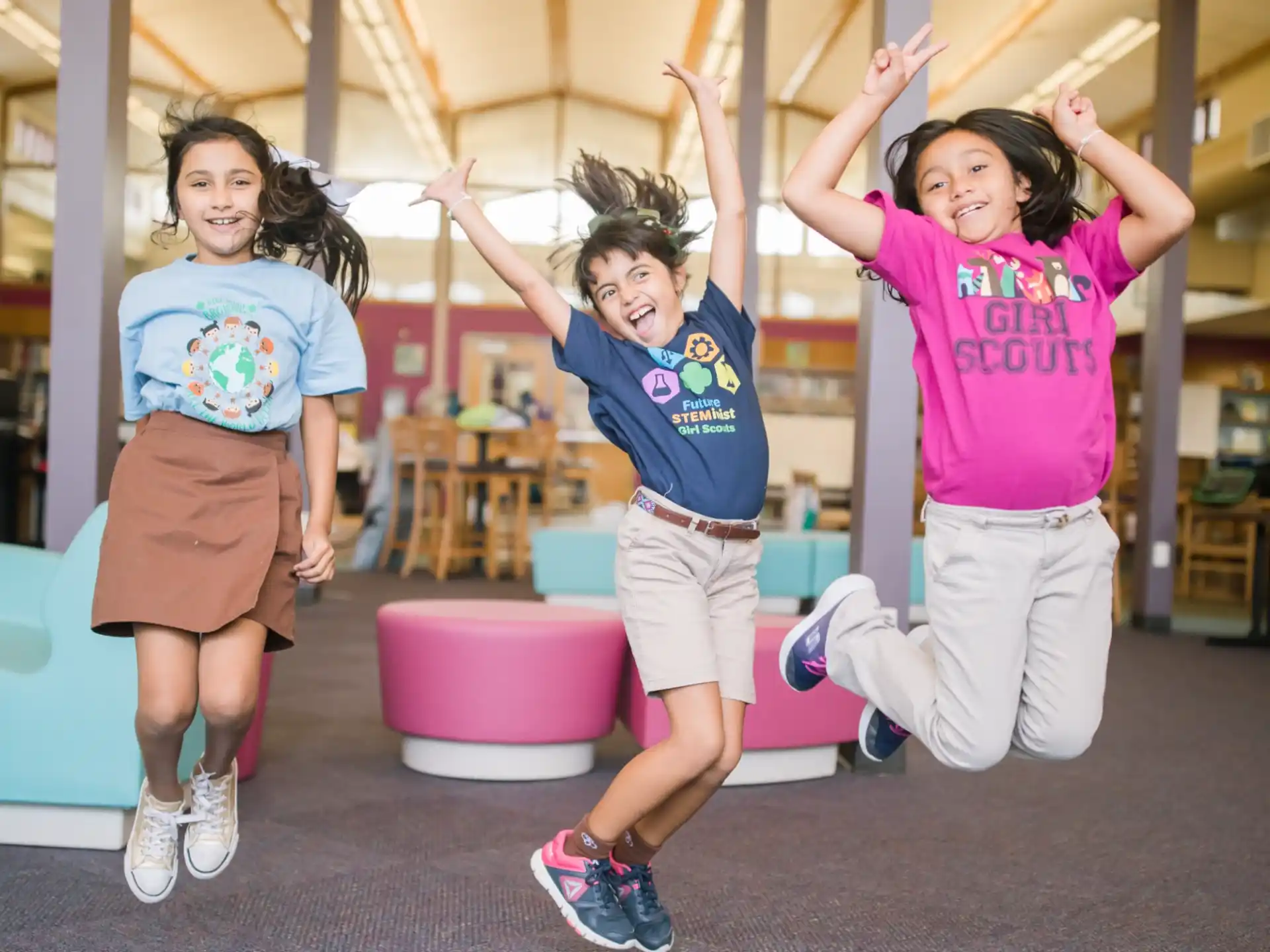 a group of girls jumping in a gym