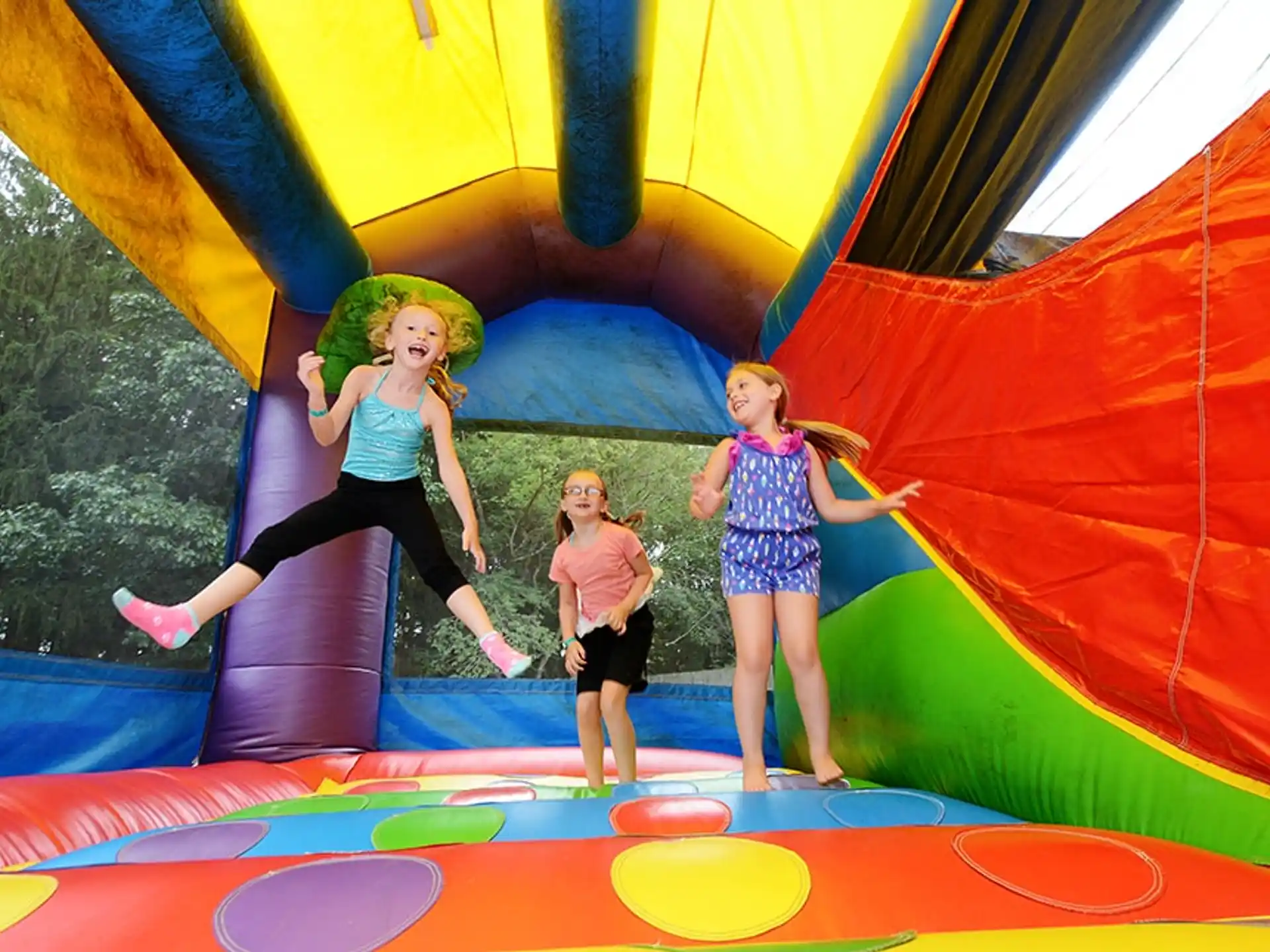 a group of girls on a slide