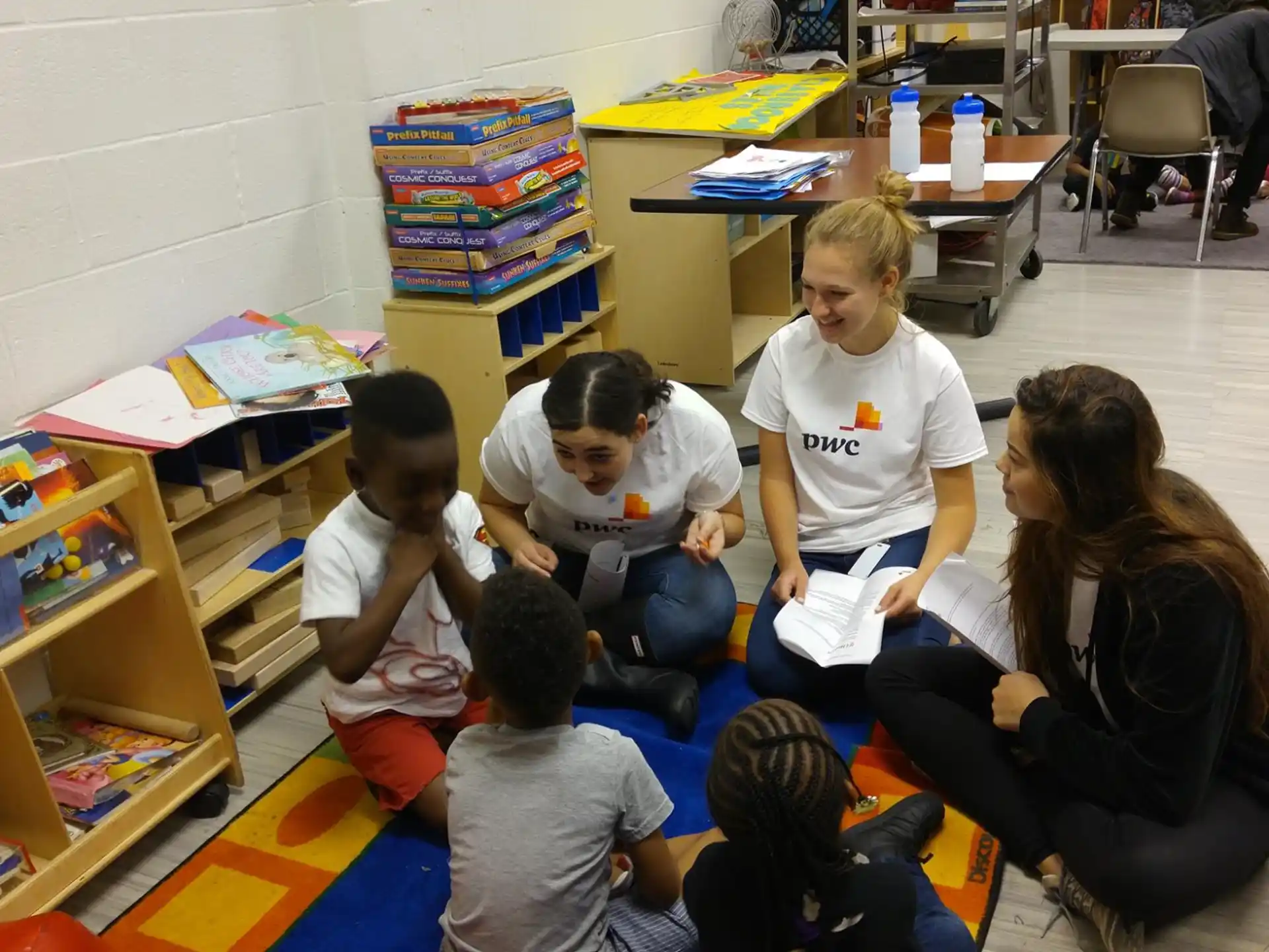a group of children sitting on the floor reading books
