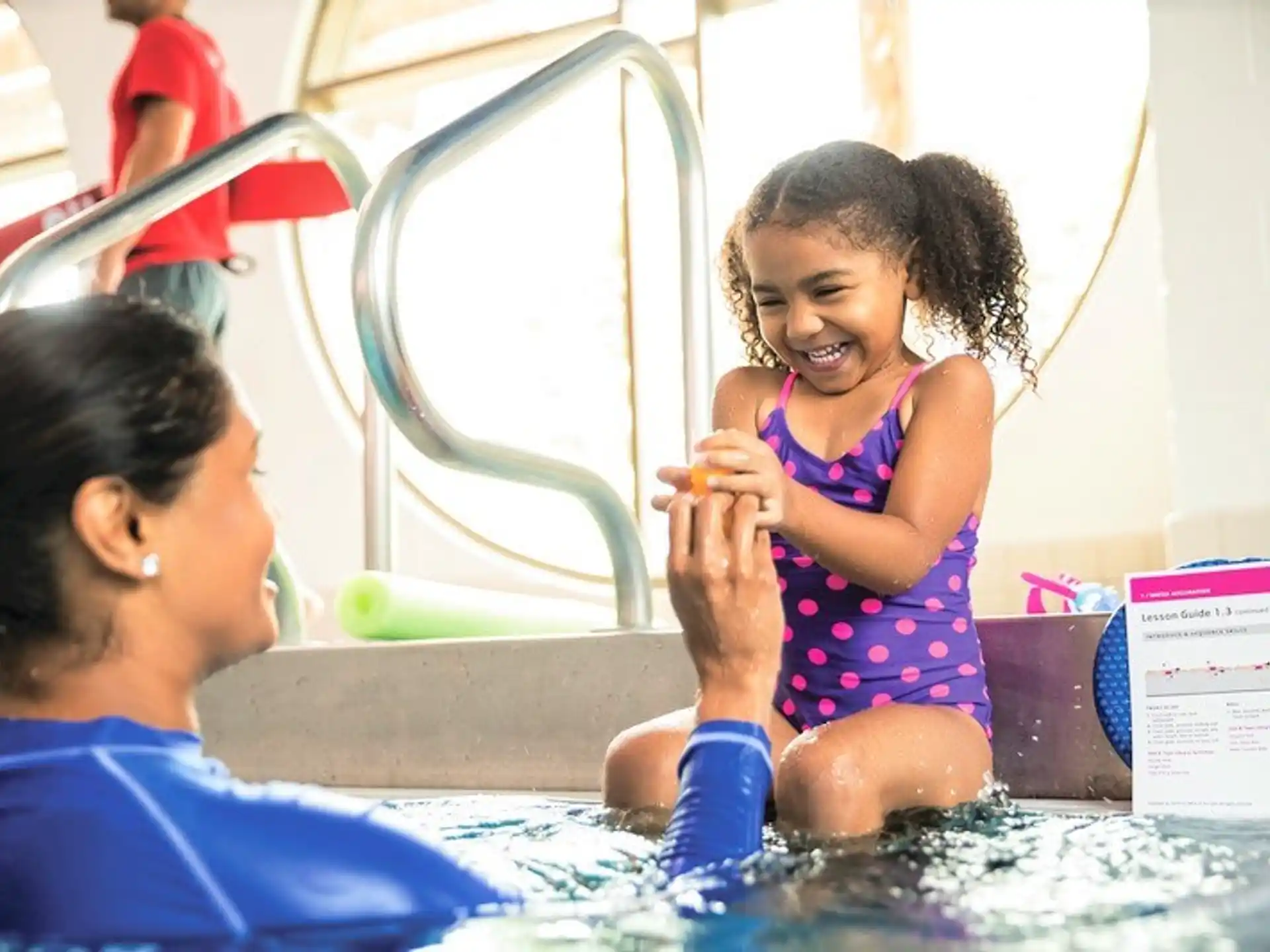 a person and a child in a pool