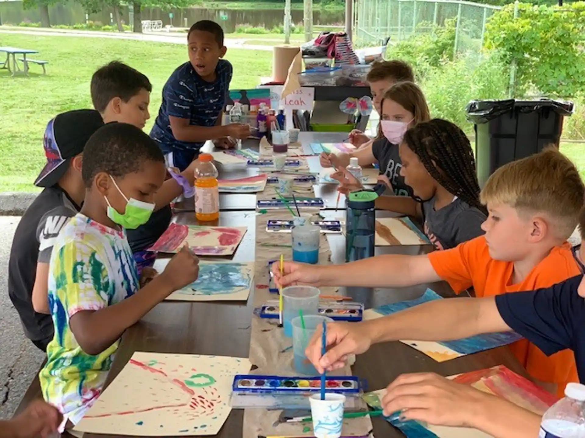 a group of children sitting around a table