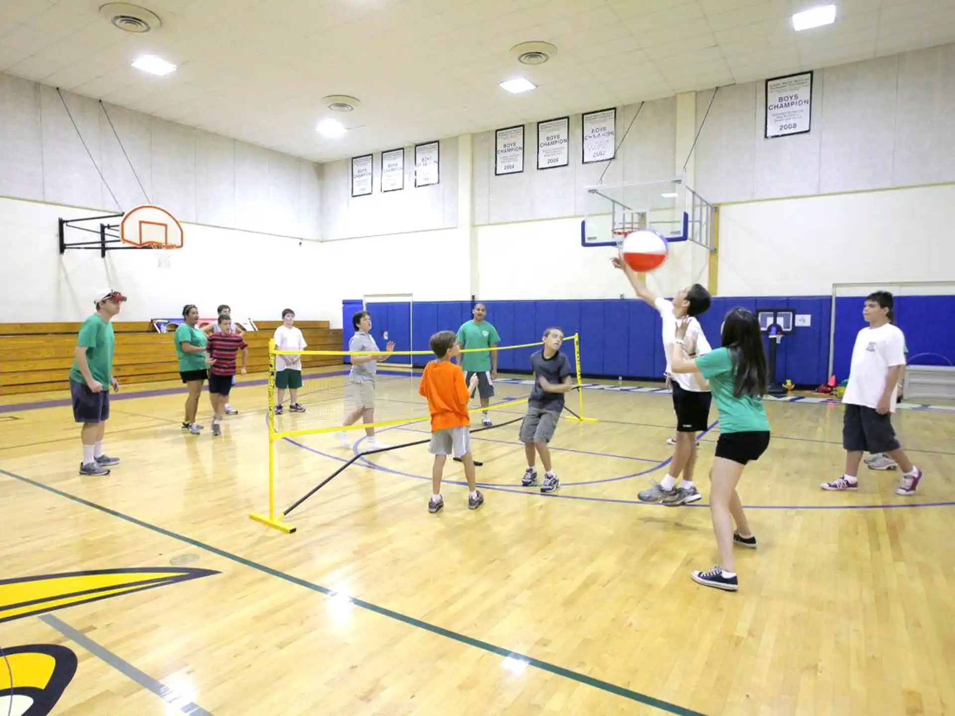 a group of people playing volleyball