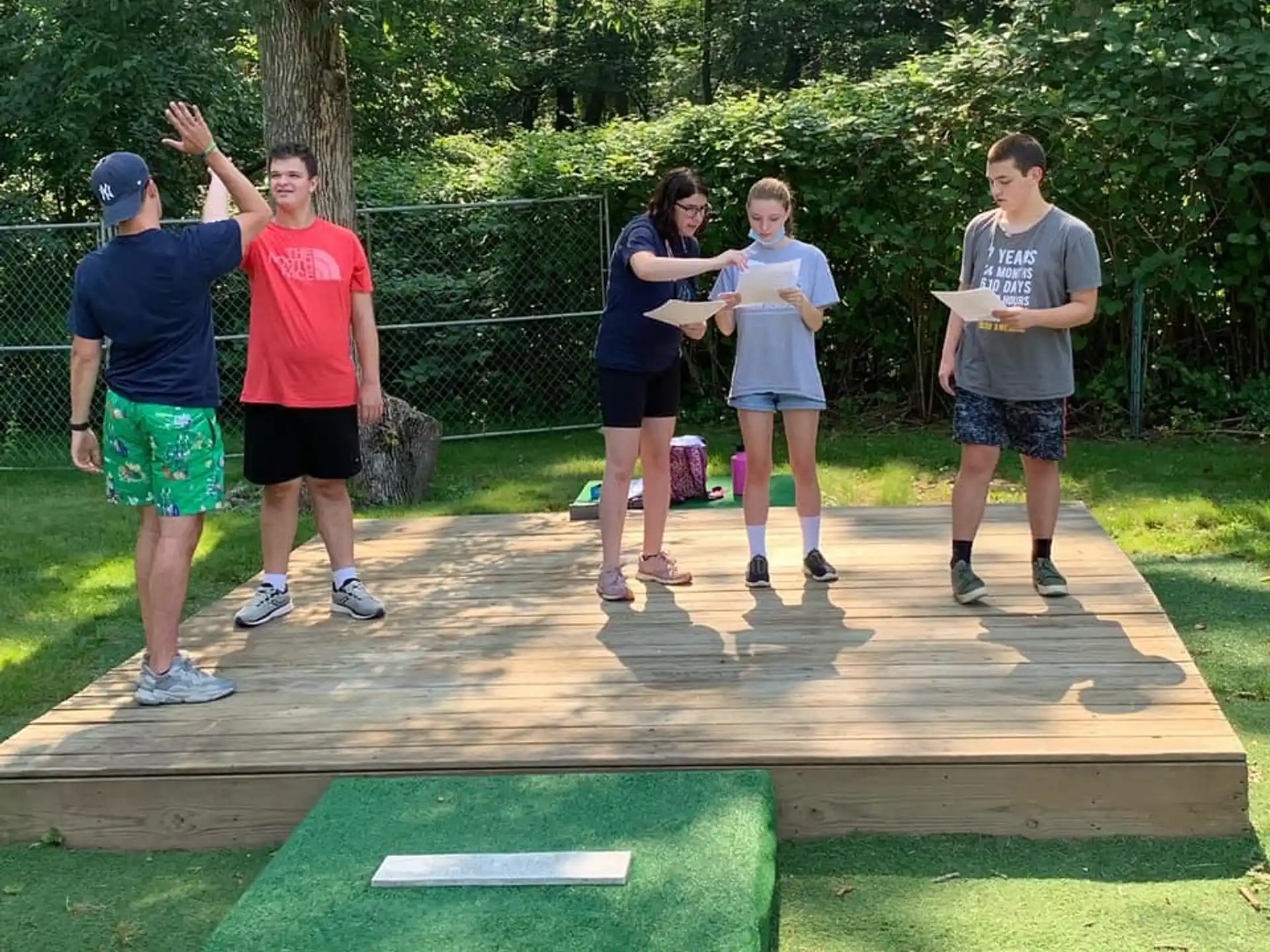 a group of people standing on a wooden deck