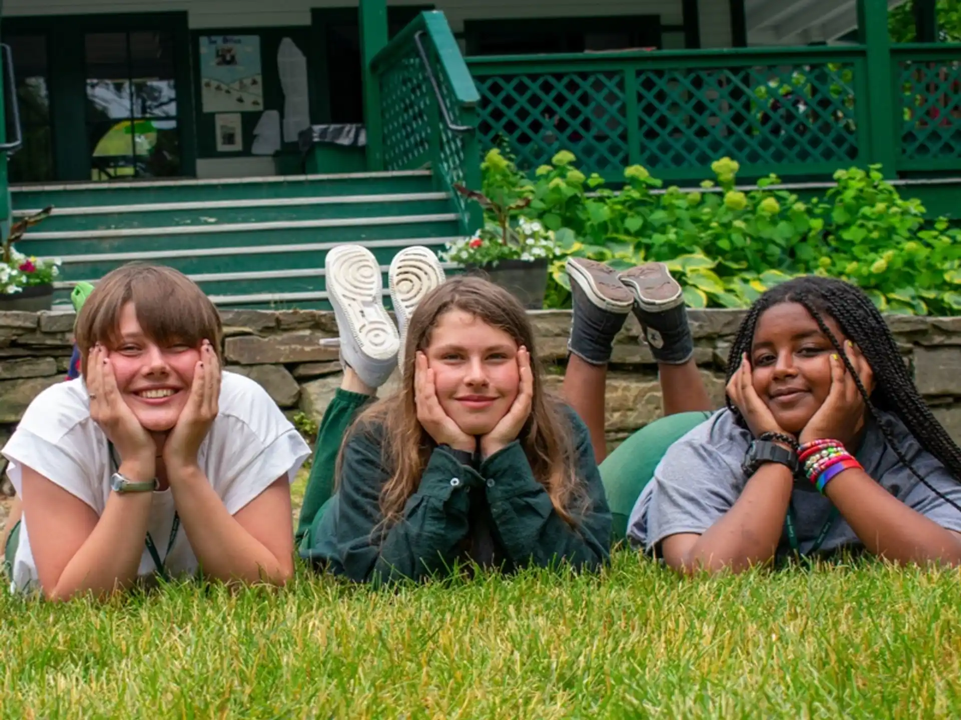 a group of girls lying in the grass